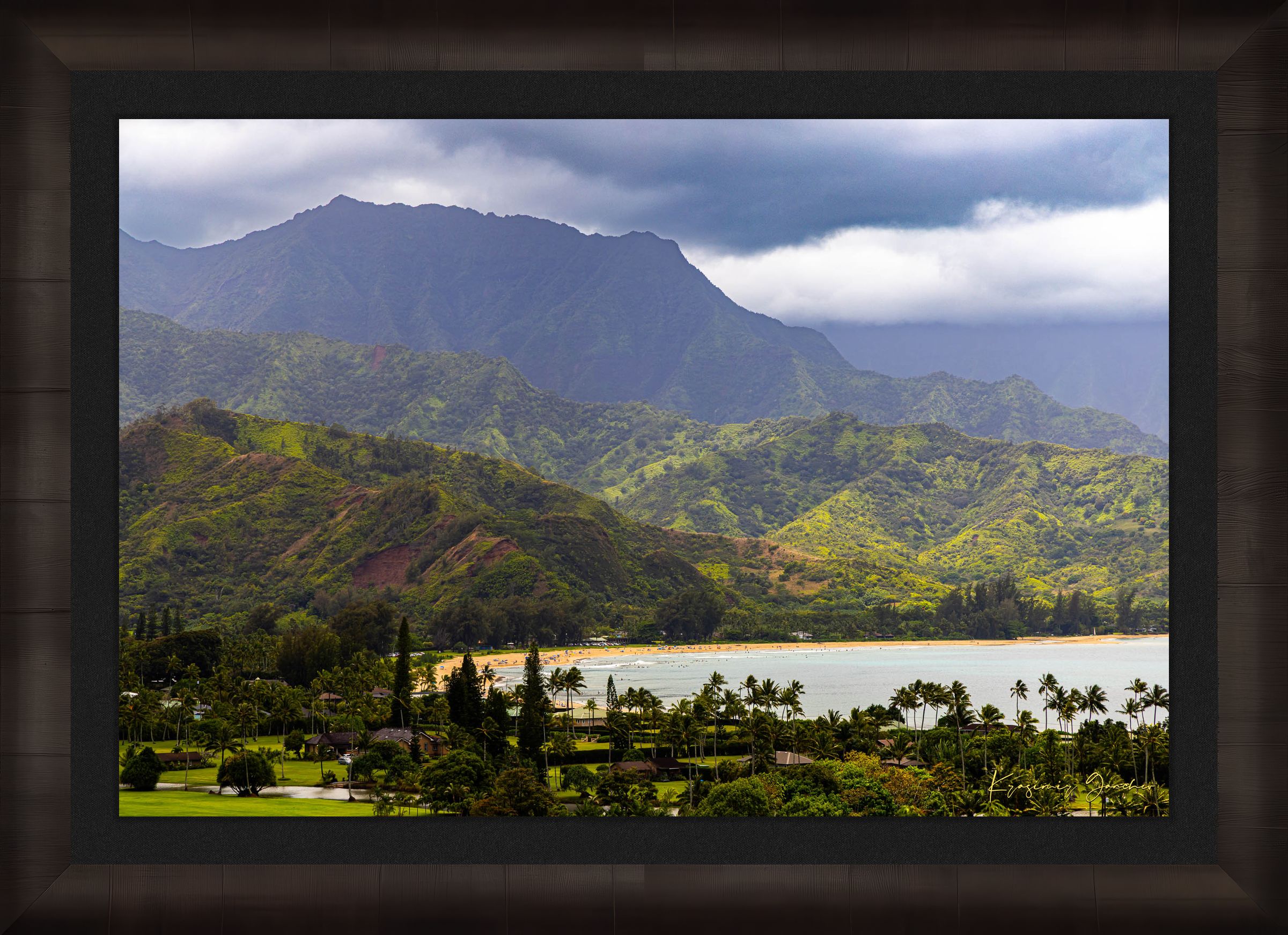 Ocean view of Hanalei Bay on Kauai's coast with lush hills and distant cloud-covered peaks. #Finish_Roma Dark Ash Frame & Dark Liner