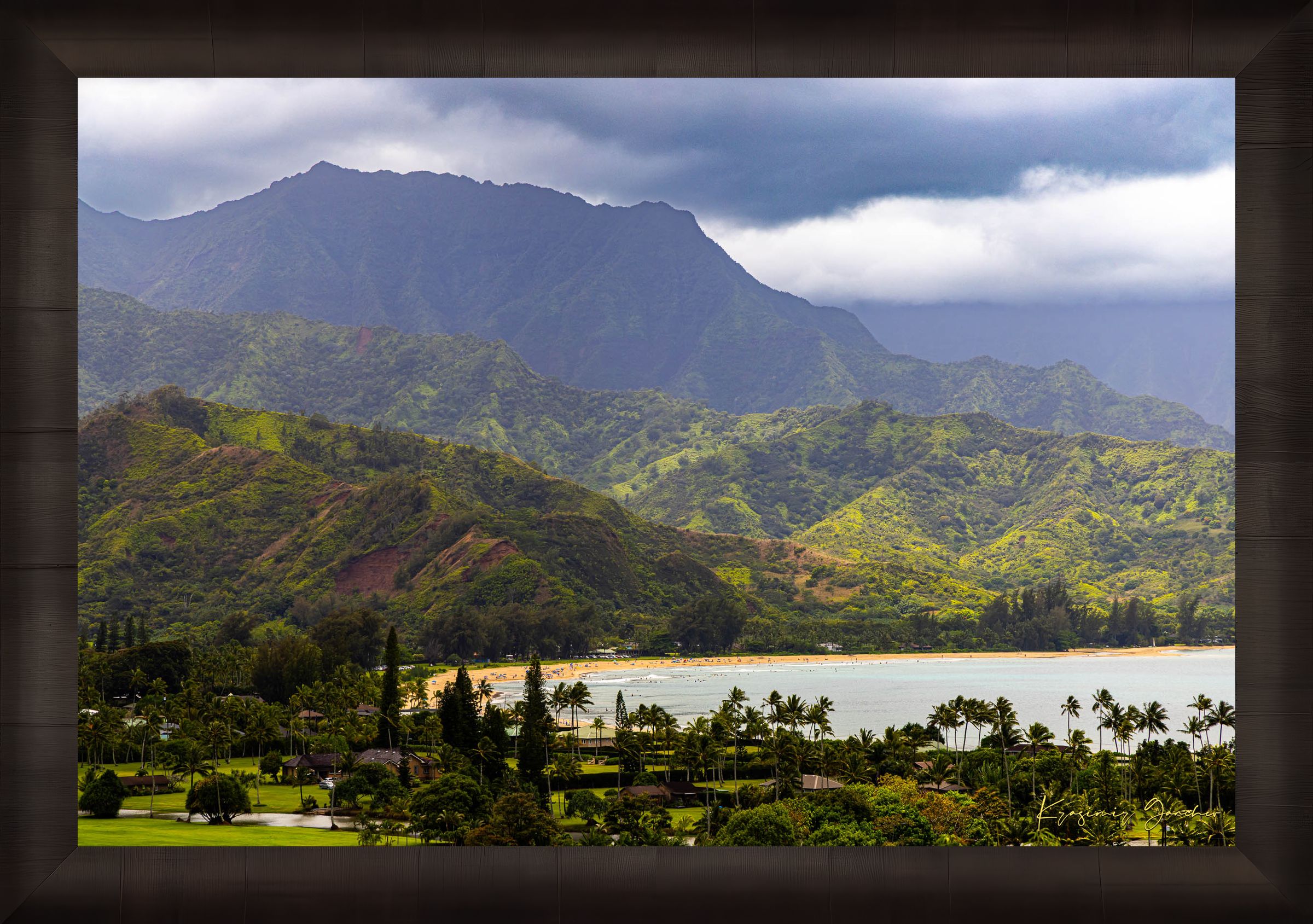 Ocean view of Hanalei Bay on Kauai's coast with lush hills and distant cloud-covered peaks. #Finish_Roma Dark Ash Frame