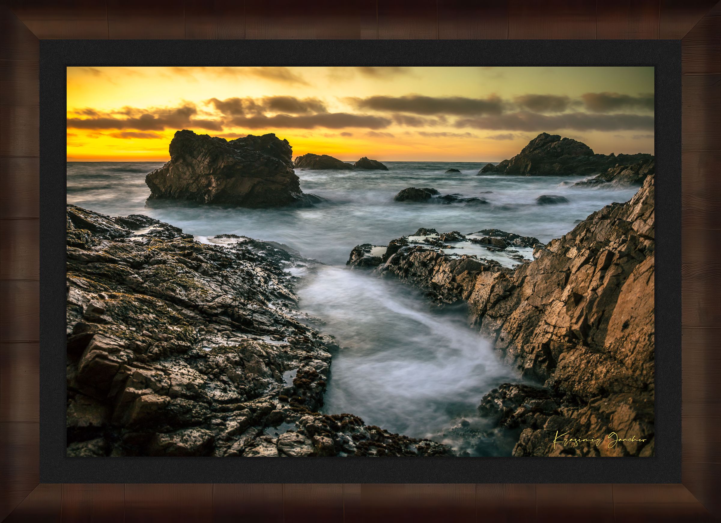 Jagged rocky cliffs along the Big Sur coast with rhythmic wave action, open ocean mist, clouds above, illuminated by late afternoon sunlight. #Finish_Roma Cigar Leaf Frame & Dark Liner