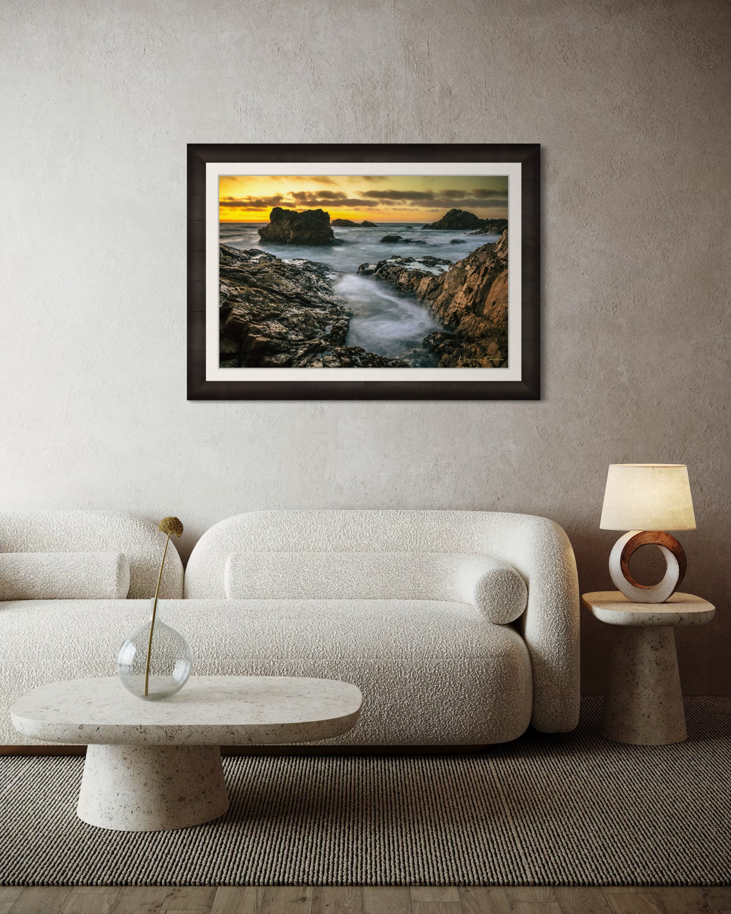 Jagged rocky cliffs along the Big Sur coast with rhythmic wave action, open ocean mist, clouds above, illuminated by late afternoon sunlight. #Finish_Roma Dark Ash Frame & Bright Liner