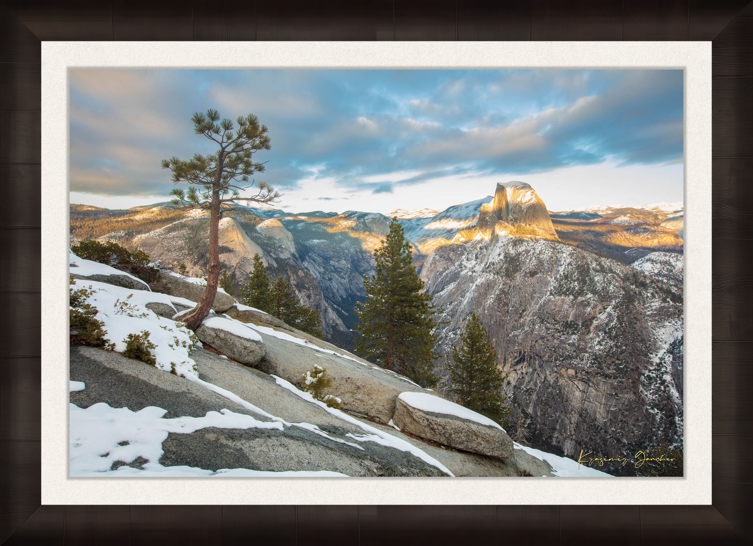 Majestic Half Dome in Yosemite National Park bathed in golden sunset light, covered in snow with wisps of cloud moving across the sky. #Finish_Roma Dark Ash Frame & Bright Liner