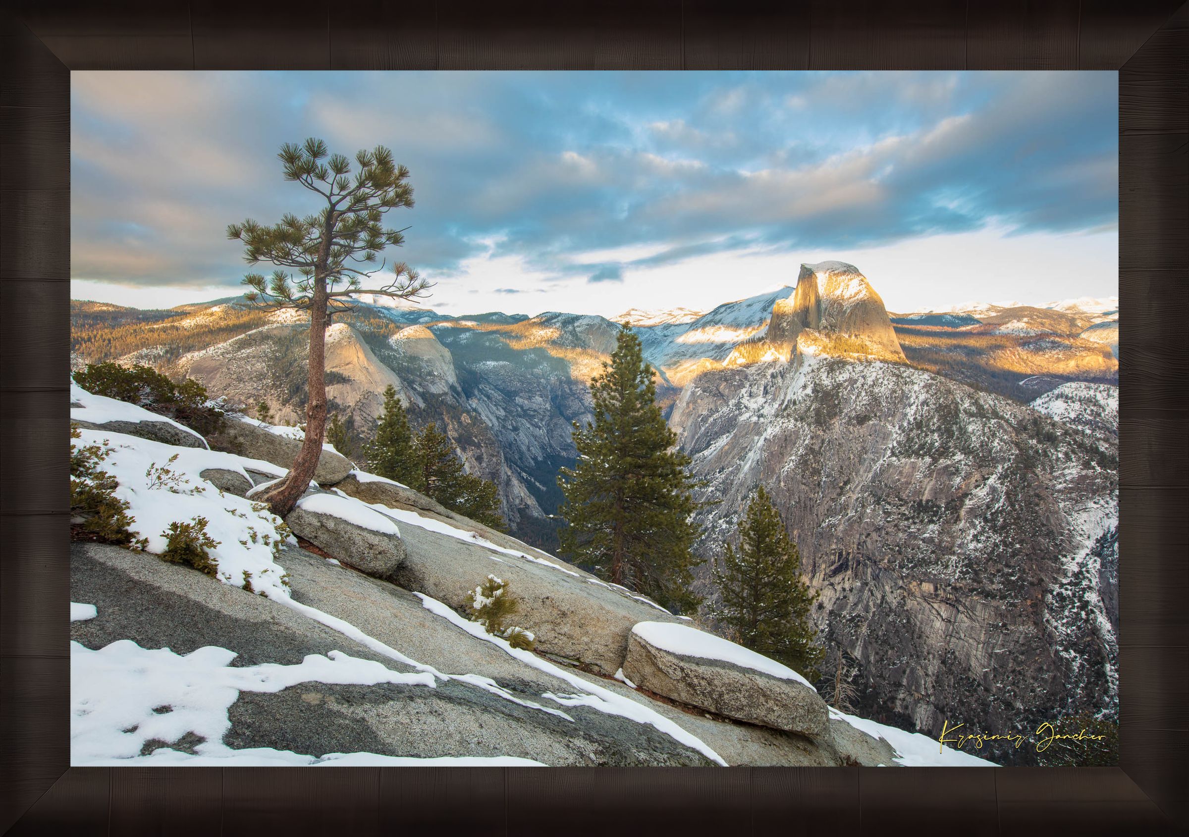 Majestic Half Dome in Yosemite National Park bathed in golden sunset light, covered in snow with wisps of cloud moving across the sky. #Finish_Roma Dark Ash Frame
