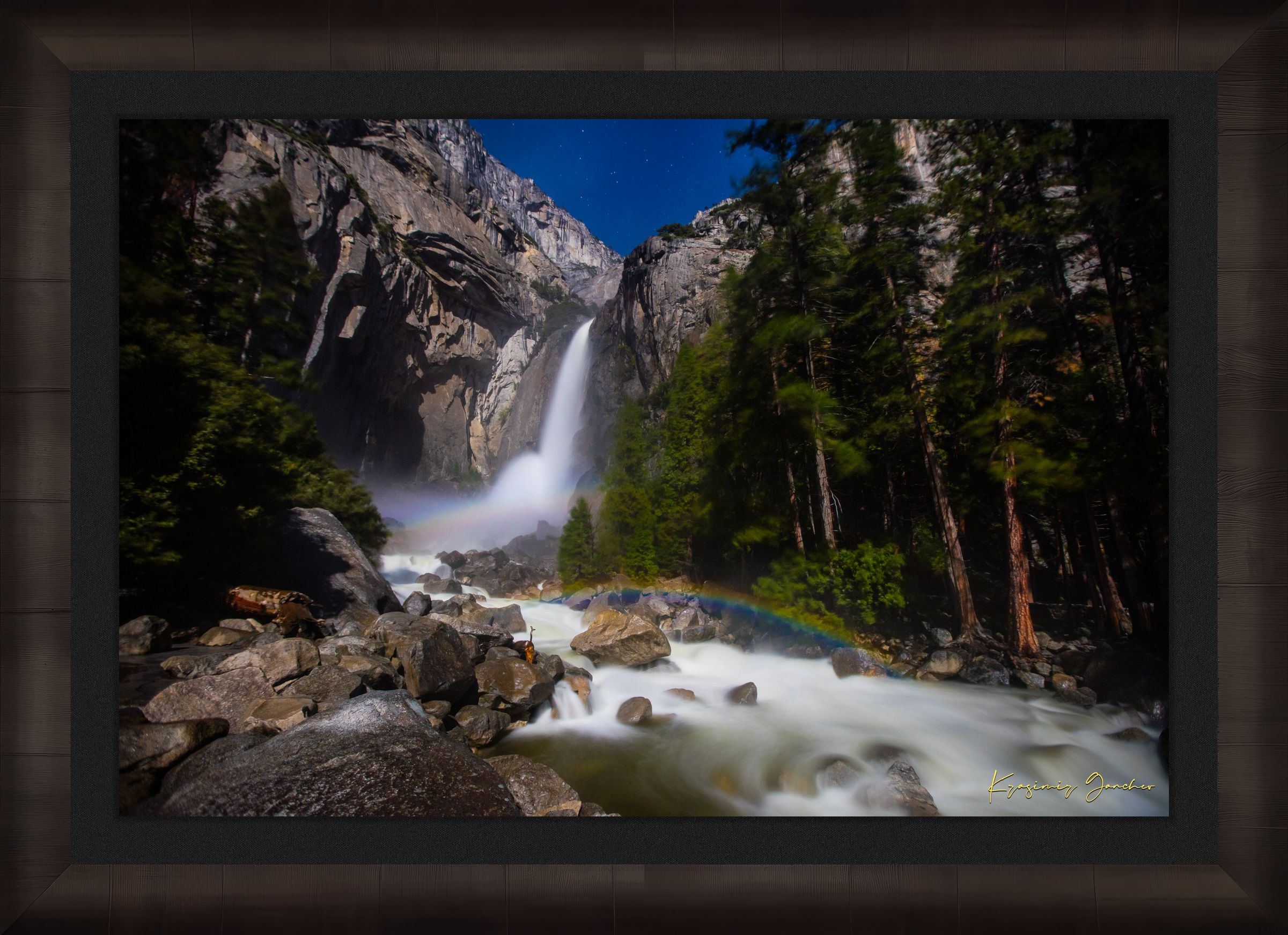 Yosemite Falls illuminated by starlight and an arc of moonbow, long exposure capturing flowing water against a clouded sky. #Finish_Roma Dark Ash Frame & Dark Liner