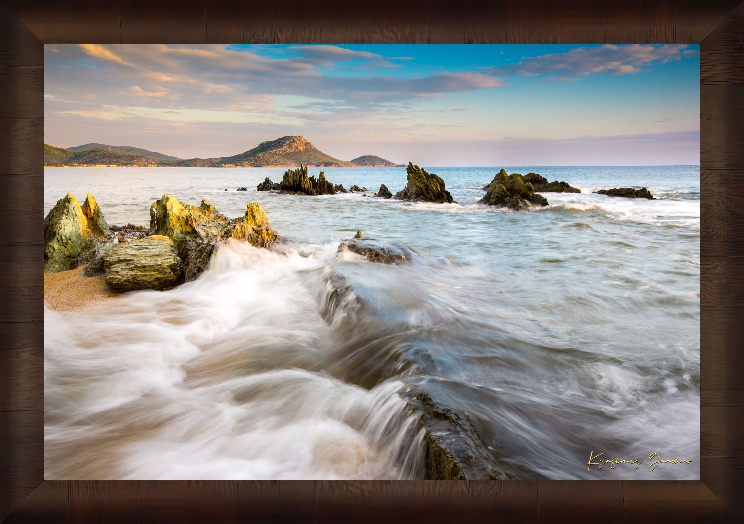Sunset view of Sithonia's coastline featuring sea, rocky beach, scattered boulders, and gentle waves. #Finish_Roma Cigar Leaf Frame