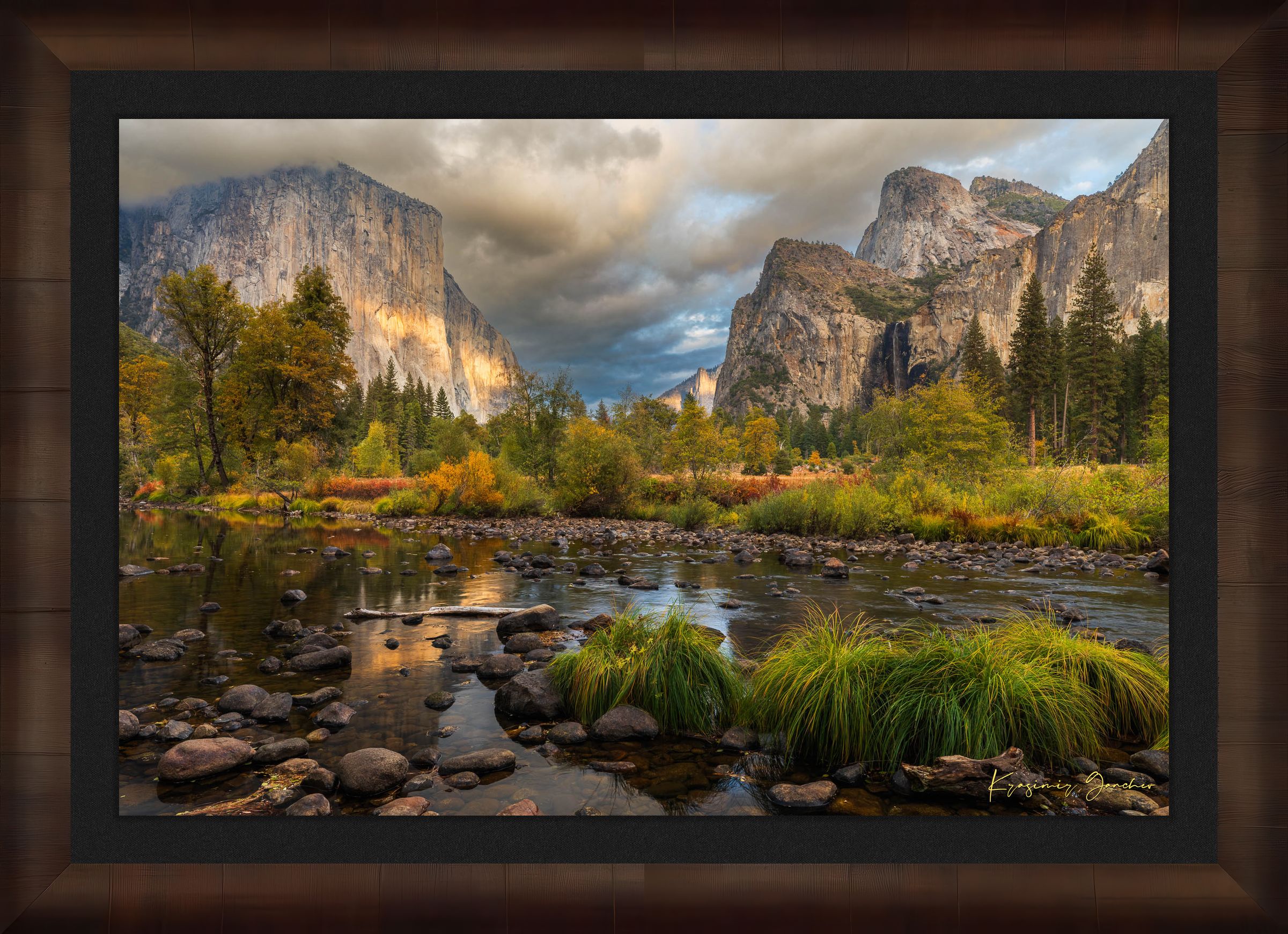 El Capitan at sunset in Yosemite Valley, golden light reflecting off the river amid clouds and seasonal tree colors. #Finish_Roma Cigar Leaf Frame & Dark Liner
