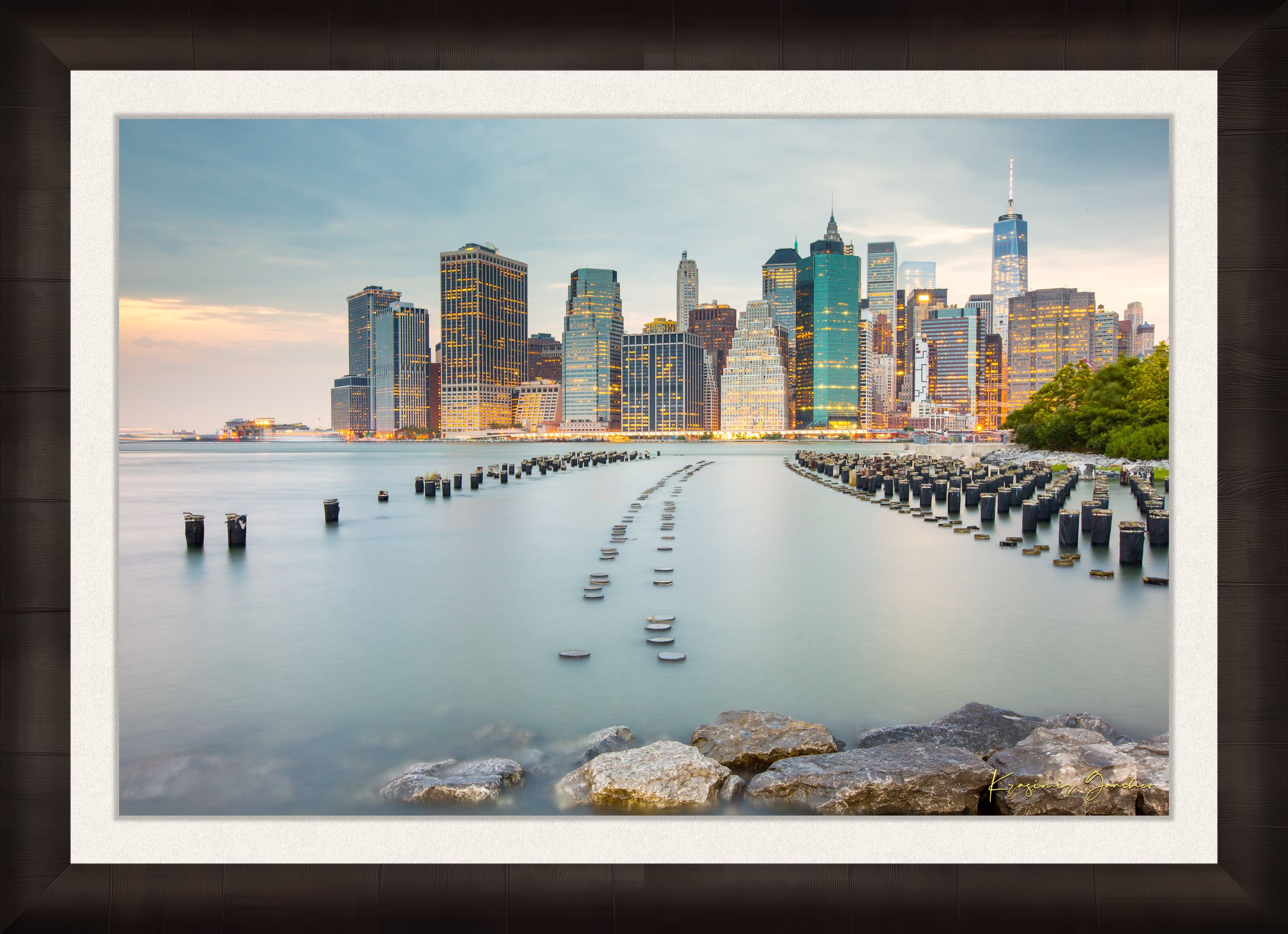 Urban waterfront scene along an estuary in Manhattan under a twilight sky with clouds and reflected city lights. #Finish_Roma Dark Ash Frame & Bright Liner