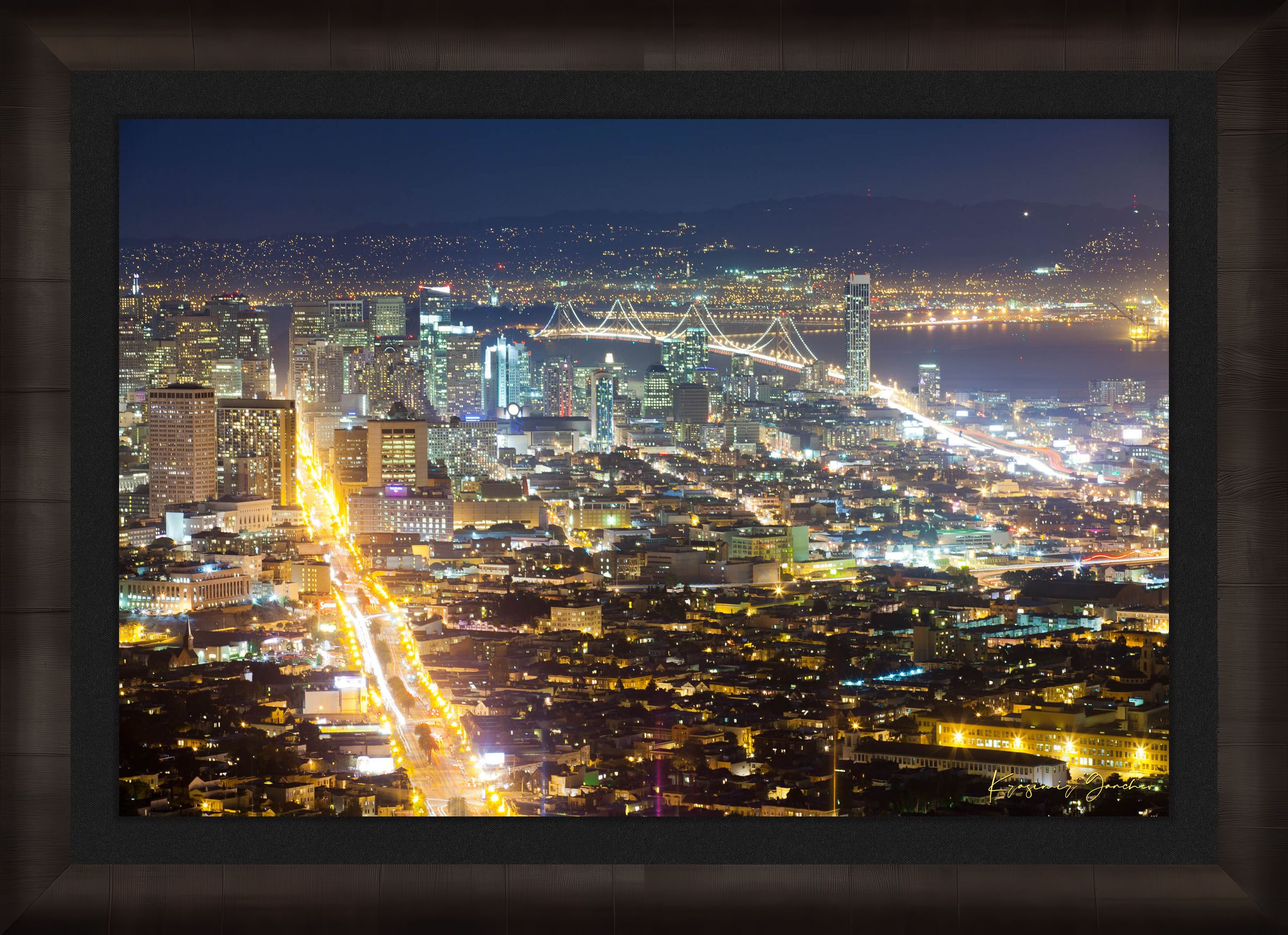 Nighttime panoramic view from Twin Peaks, San Francisco, with illuminated city lights reflected on the bay through a layer of mist. #Finish_Roma Dark Ash Frame & Dark Liner