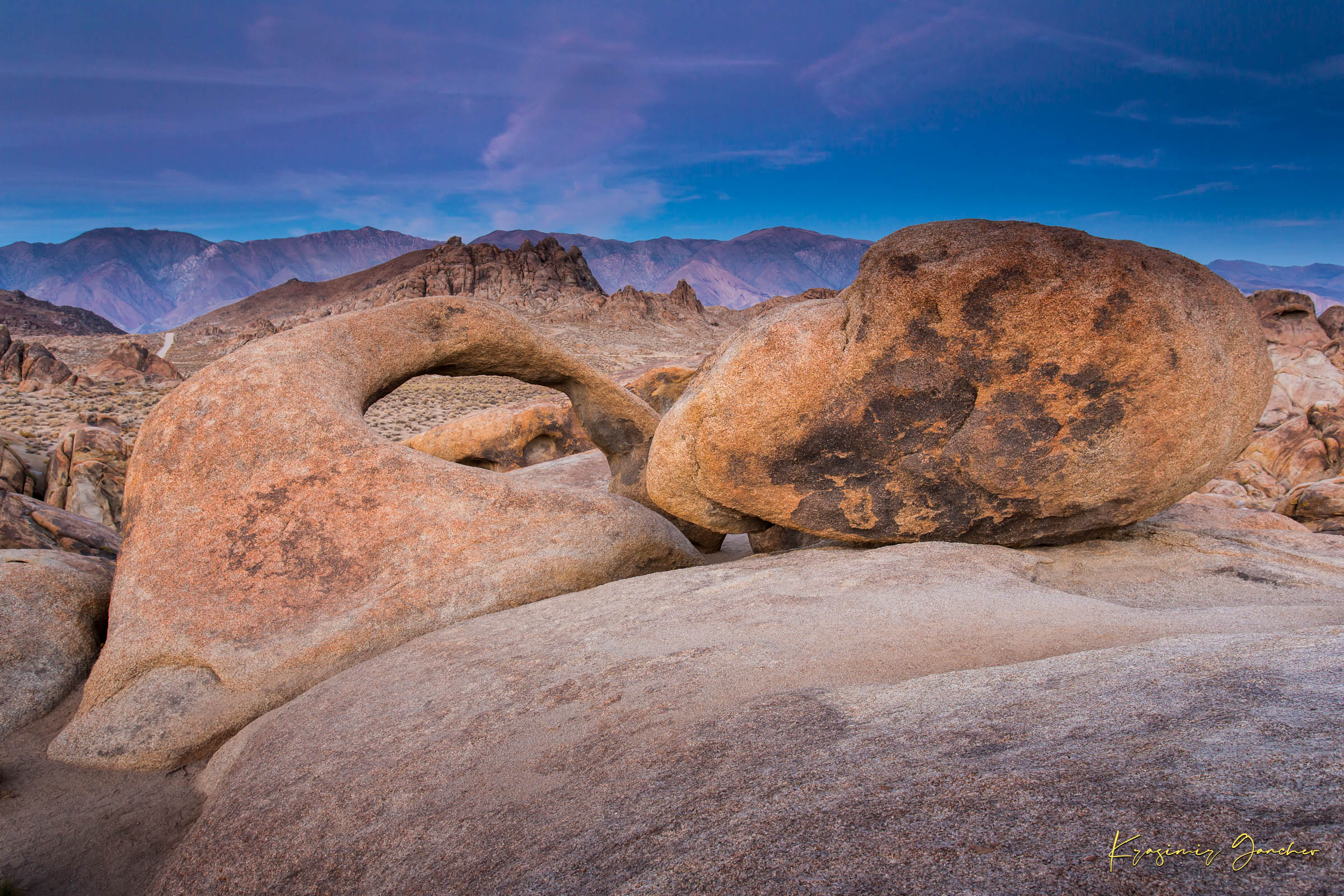Natural sandstone arch standing against a dusky sky with scattered clouds and dry terrain in Inyo National Forest. #Finish_Acrylic Recess