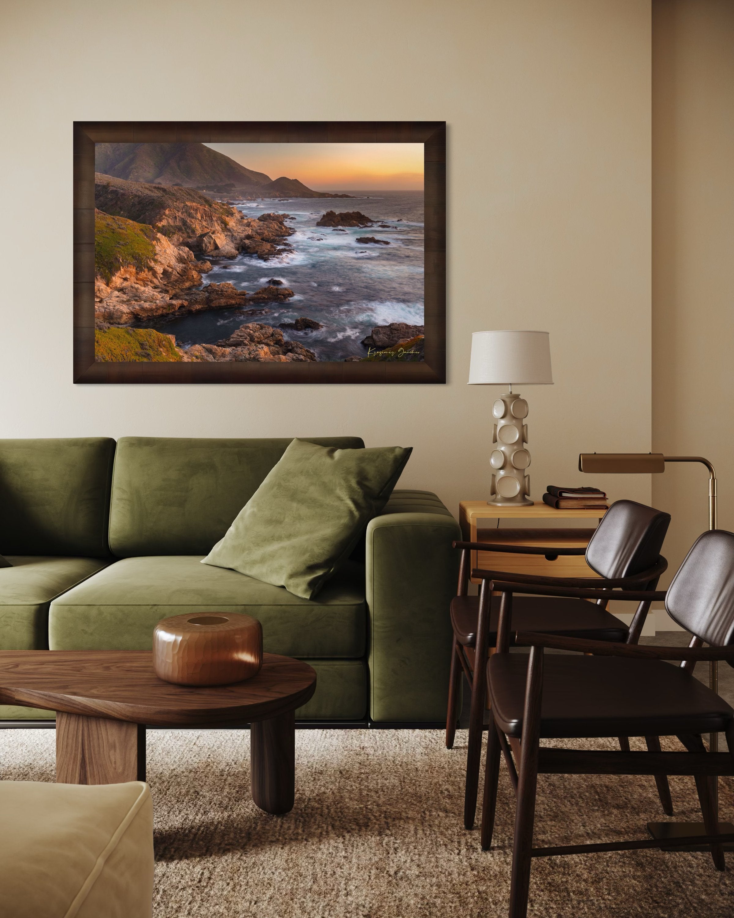 Rugged coastline of Big Sur featuring dark boulder formations, green slopes, ocean waves, and soft sunset glow across land and sea. #Finish_Roma Cigar Leaf Frame