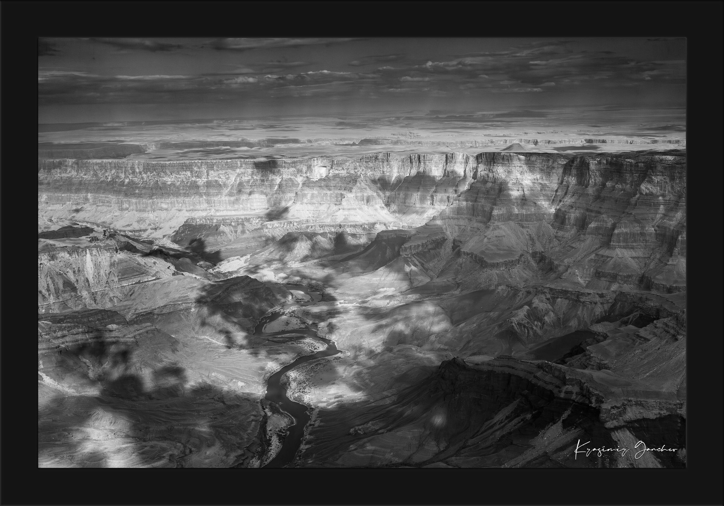 Grand Canyon National Park with Colorado River flowing through canyon and desert terrain under daylight conditions. #Finish_Roma Satin Black Frame