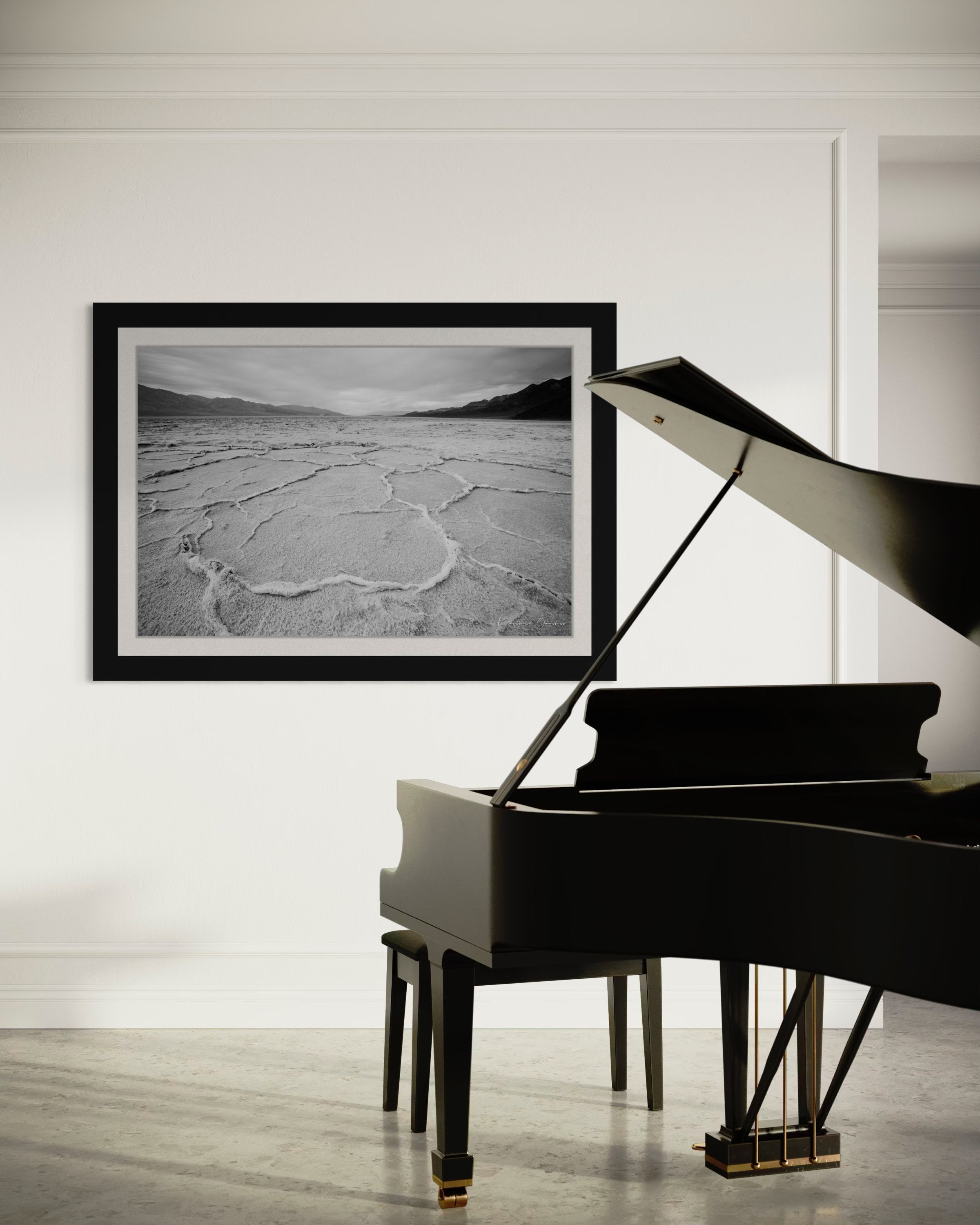 Cracked salt flat landscape in Death Valley National Park during sunset, showing textured surface under clear skies. #Finish_Roma Satin Black Frame & Bright Liner
