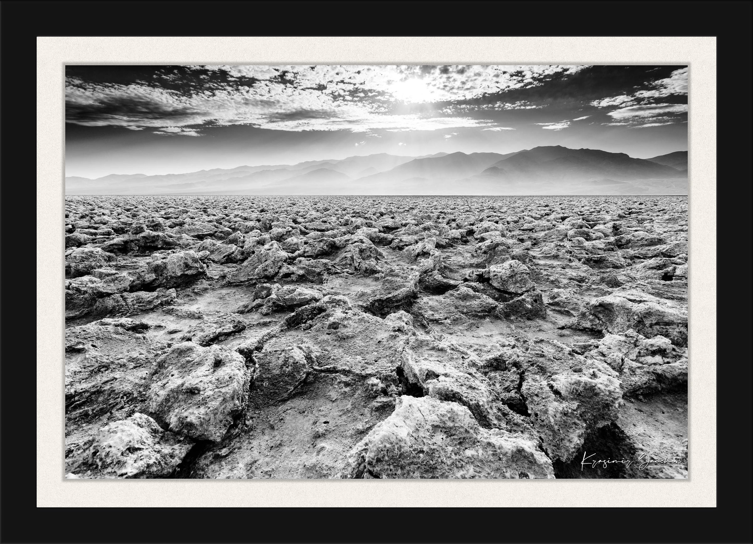 Textured salt pan terrain at Devil's Golf Course in Death Valley National Park under daytime light. #Finish_Roma Satin Black Frame & Bright Liner