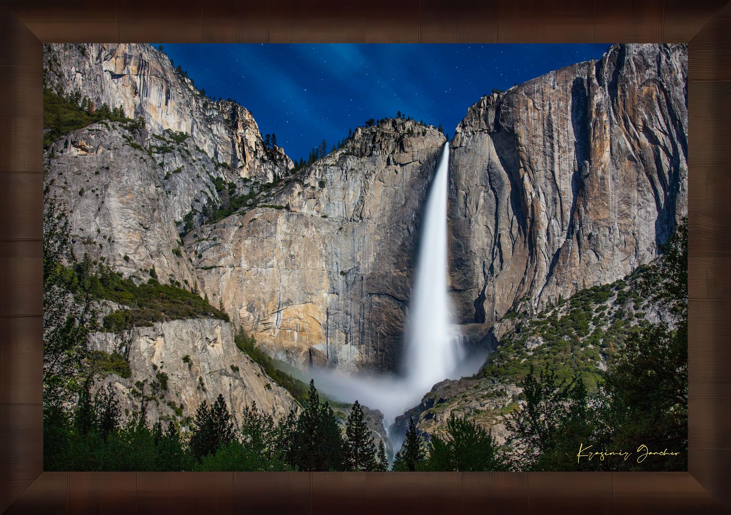 Upper Yosemite Falls illuminated by moonlight against a dark mountainous backdrop at night with cloud cover. #Finish_Roma Cigar Leaf Frame