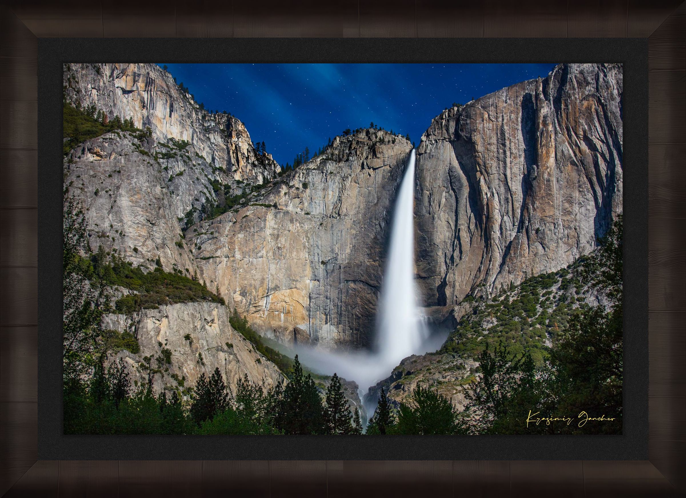 Upper Yosemite Falls illuminated by moonlight against a dark mountainous backdrop at night with cloud cover. #Finish_Roma Dark Ash Frame & Dark Liner