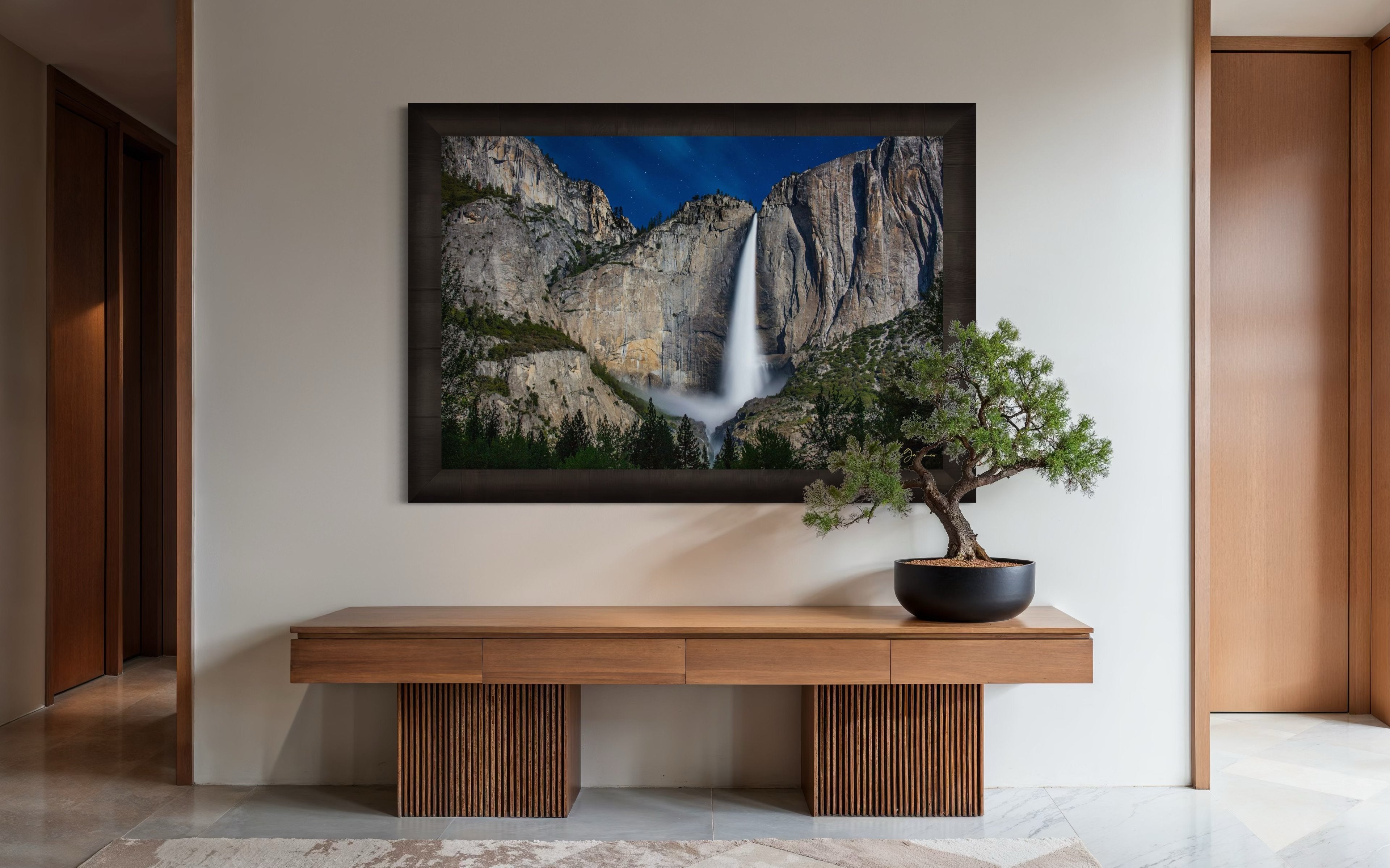 Upper Yosemite Falls illuminated by moonlight against a dark mountainous backdrop at night with cloud cover. #Finish_Roma Dark Ash Frame
