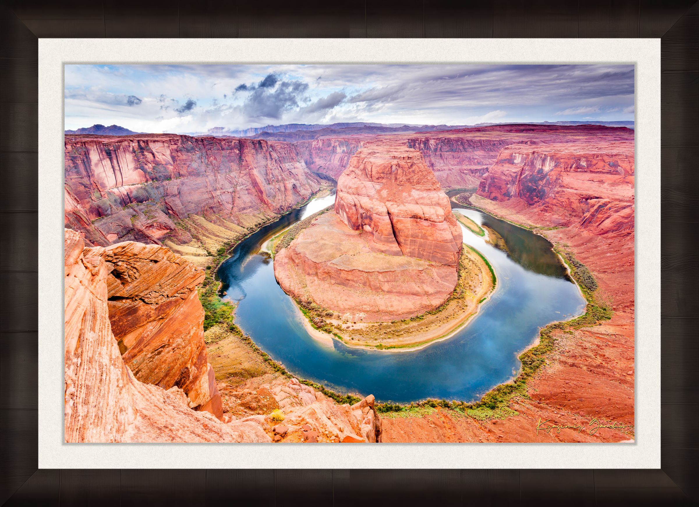 Colorado River curves through Horseshoe Bend at dawn. Water reflects sunlight and surrounding red rock cliffs under cloudy skies. #Finish_Roma Dark Ash Frame & Bright Liner