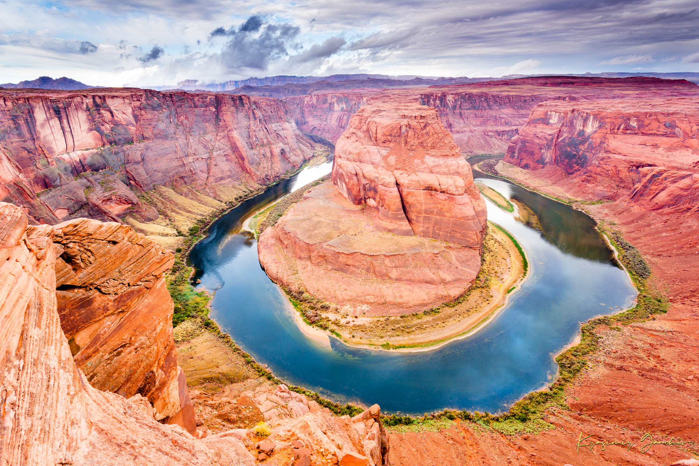 Colorado River curves through Horseshoe Bend at dawn. Water reflects sunlight and surrounding red rock cliffs under cloudy skies. #Finish_Acrylic Recess