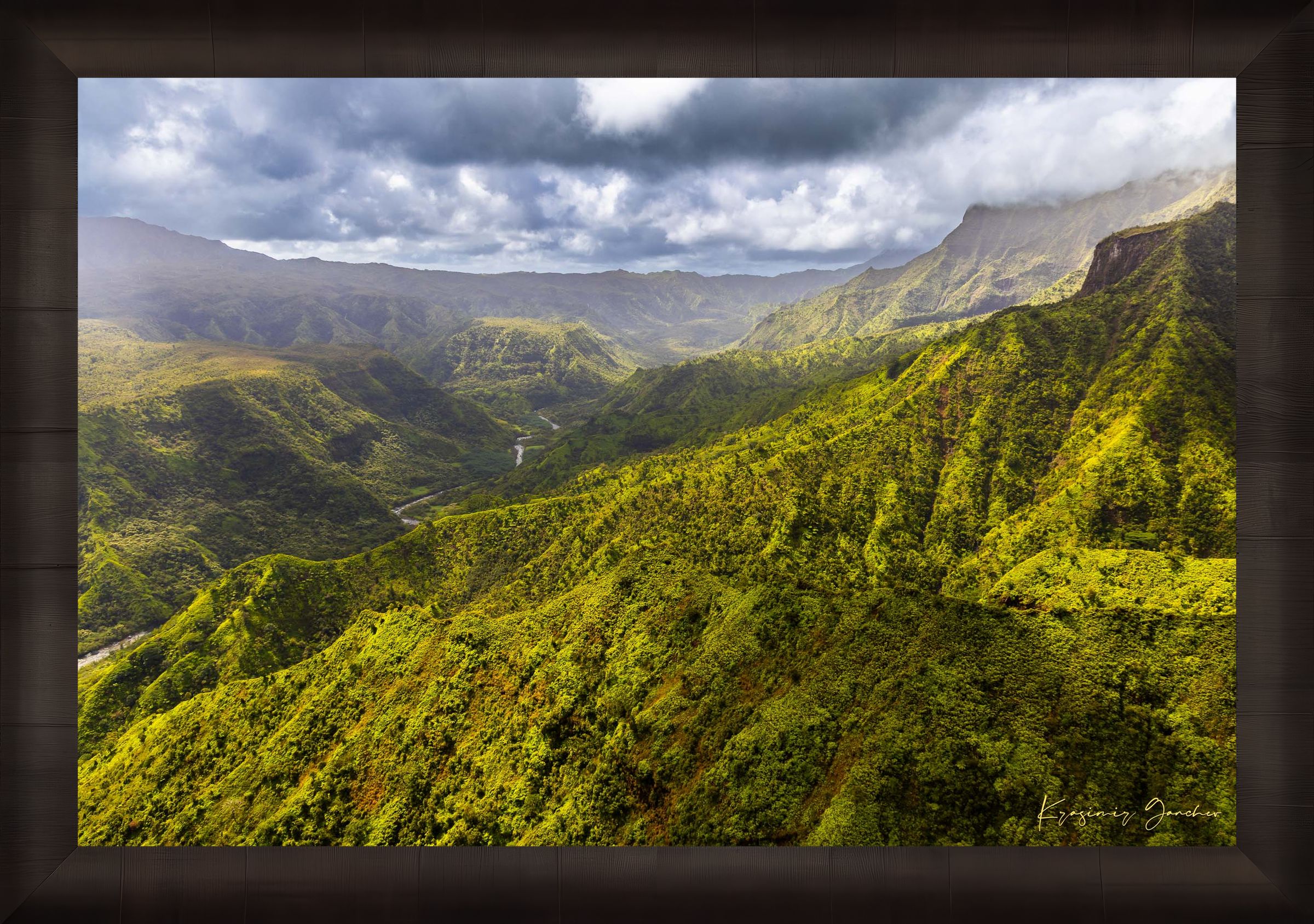 Expansive aerial view of a mountainous valley in Kauai illuminated by daylight, covered in low-lying cloud. #Finish_Roma Dark Ash Frame