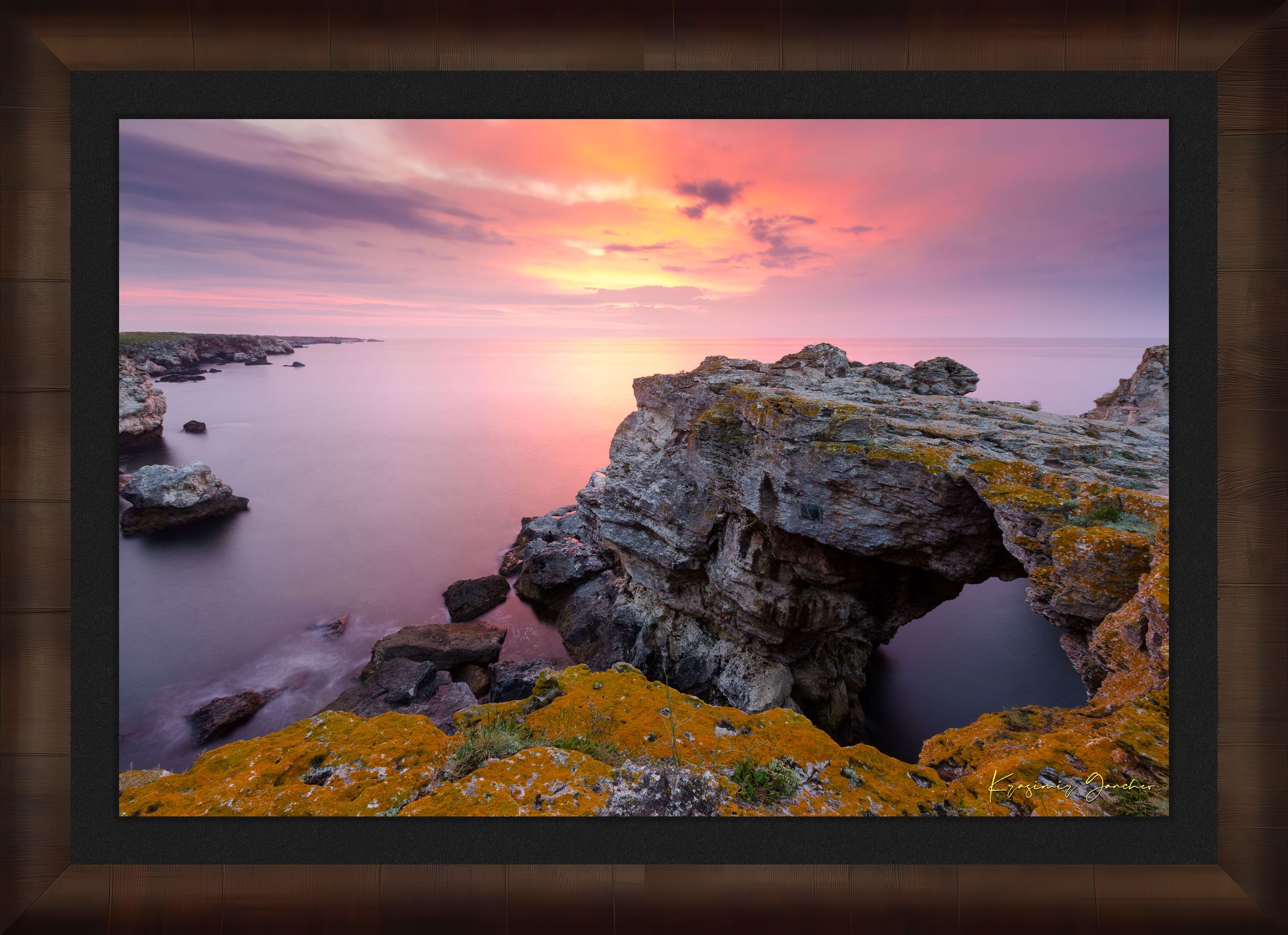 The natural arch formation of the Tyulenovo Arch at dawn in Tyulenovo, Bulgaria, lit by sunrise and surrounded by vegetation. #Finish_Roma Cigar Leaf Frame & Dark Liner