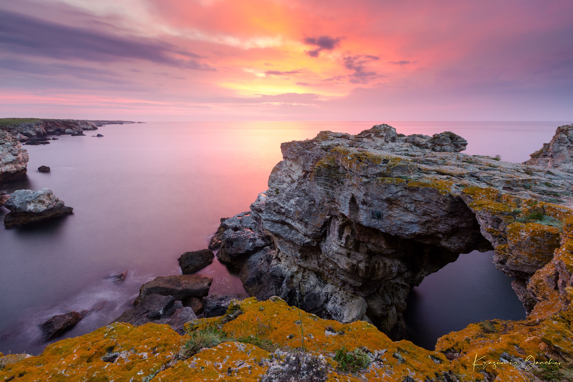 The natural arch formation of the Tyulenovo Arch at dawn in Tyulenovo, Bulgaria, lit by sunrise and surrounded by vegetation. #Finish_Acrylic Recess
