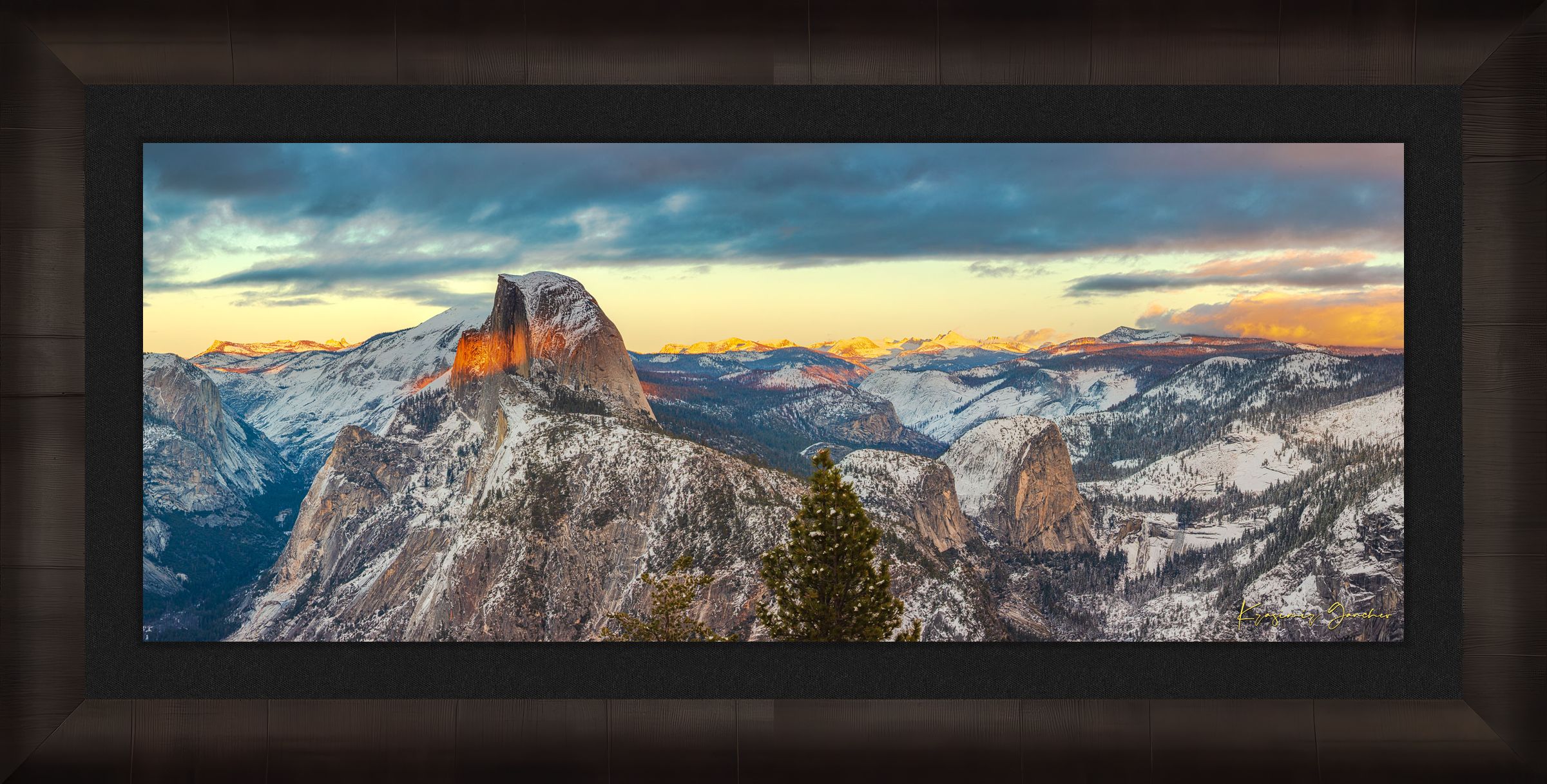 Sunset view of Half Dome monolith with dynamic shadows and sunlight over snow-dusted peaks and clouds in Yosemite National Park. #Finish_Roma Dark Ash Frame & Dark Liner