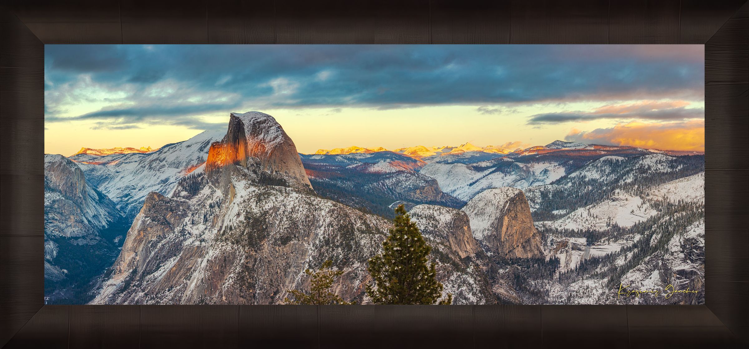 Sunset view of Half Dome monolith with dynamic shadows and sunlight over snow-dusted peaks and clouds in Yosemite National Park. #Finish_Roma Dark Ash Frame