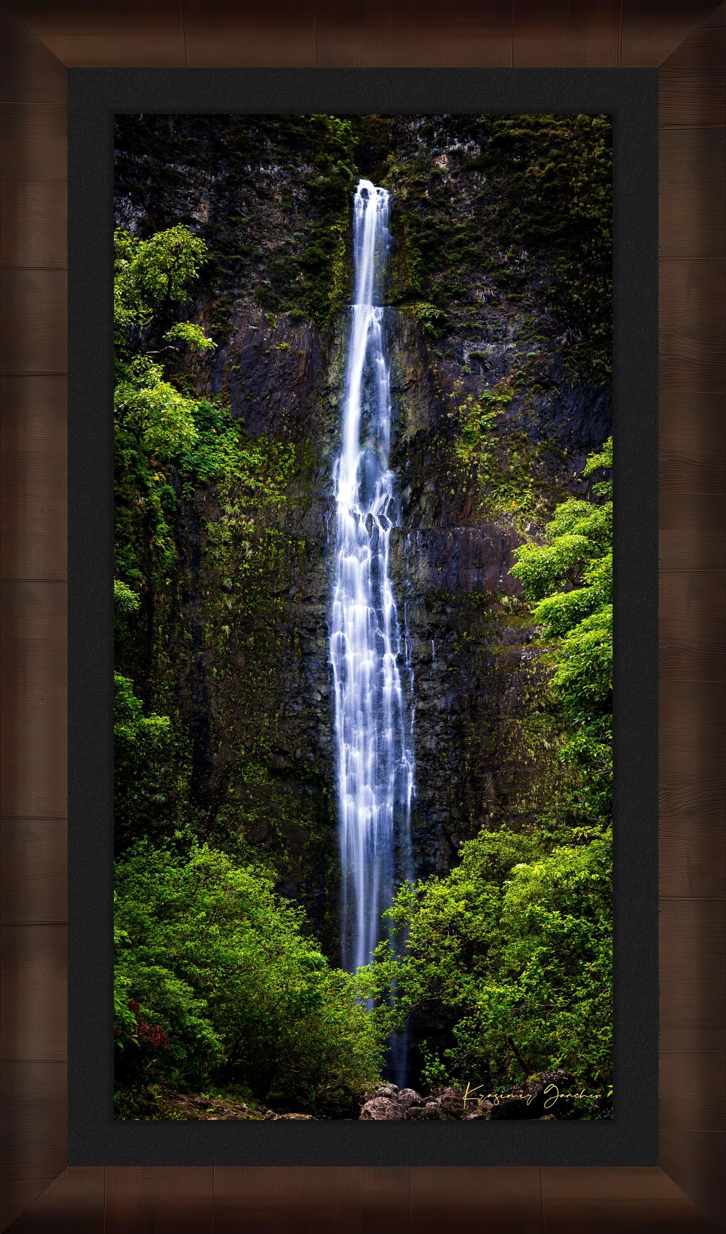 Waterfall cascading down cliff face within Na Pali Coast region of Kauai under daylight conditions. #Finish_Roma Cigar Leaf Frame & Dark Liner