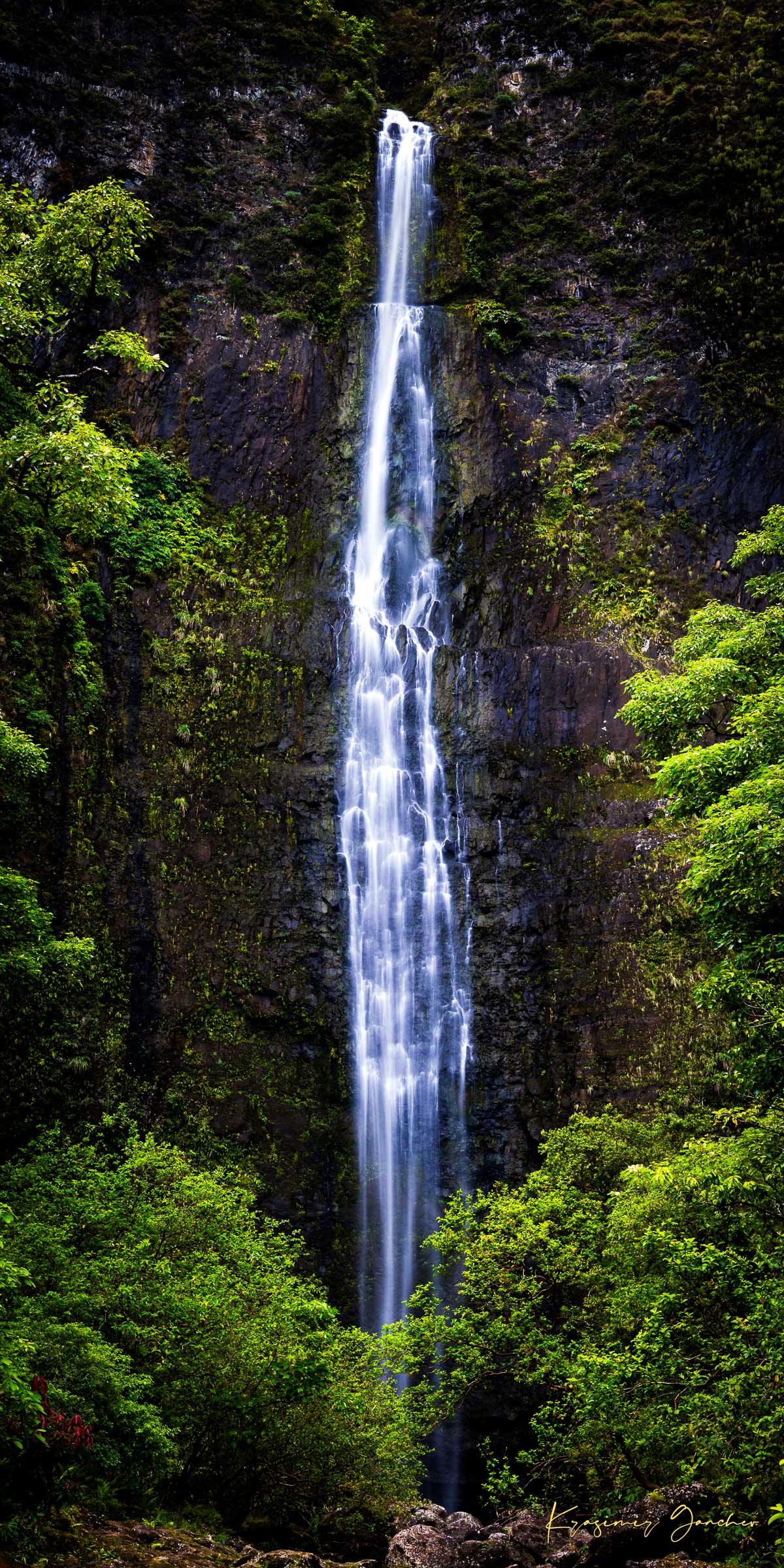 Waterfall cascading down cliff face within Na Pali Coast region of Kauai under daylight conditions. #Finish_Acrylic Recess