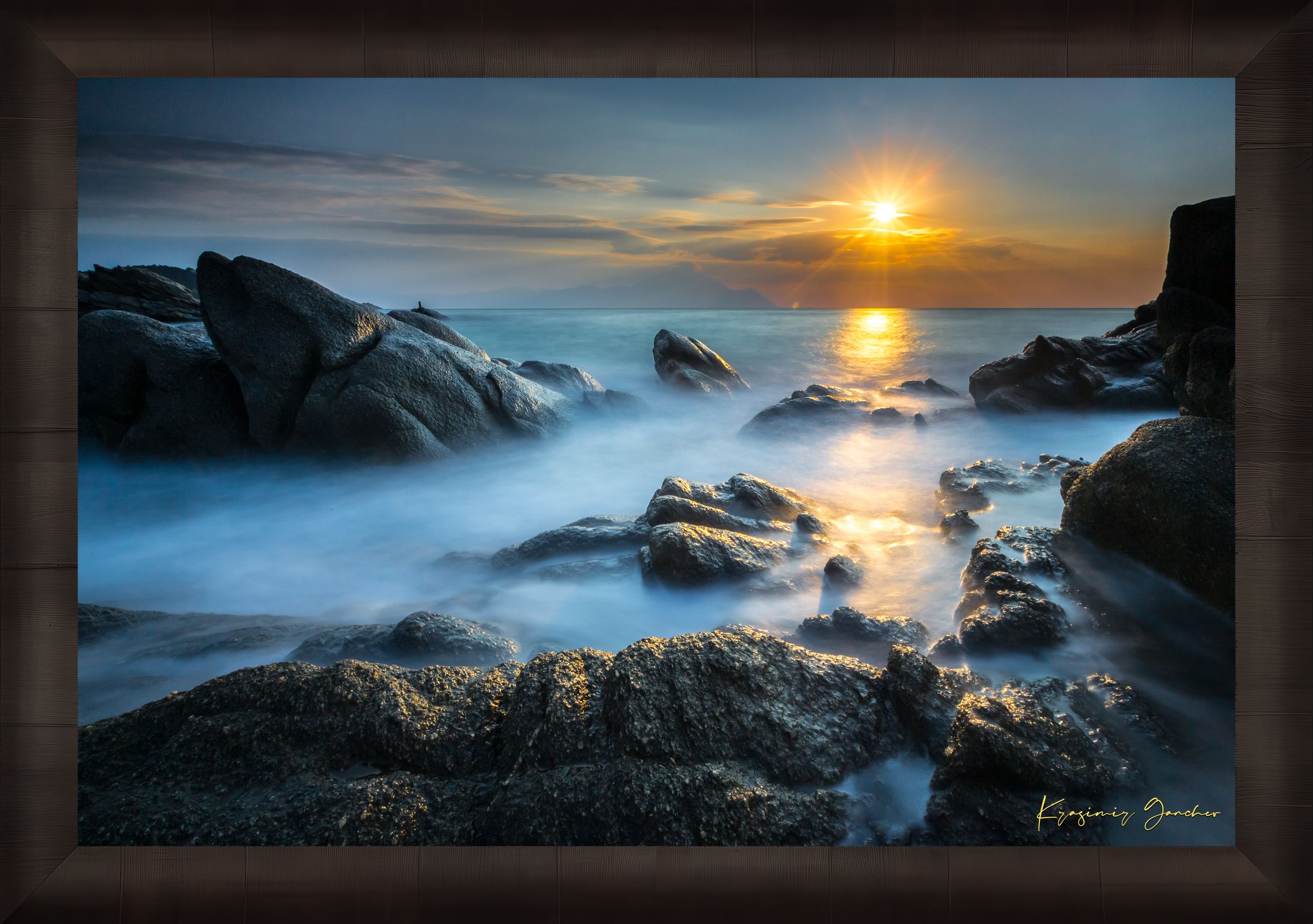 Coastal rocks with a sea stack at sunrise, soft light on the moving sea surface. Taken in Sarti, Greece. #Finish_Roma Dark Ash Frame