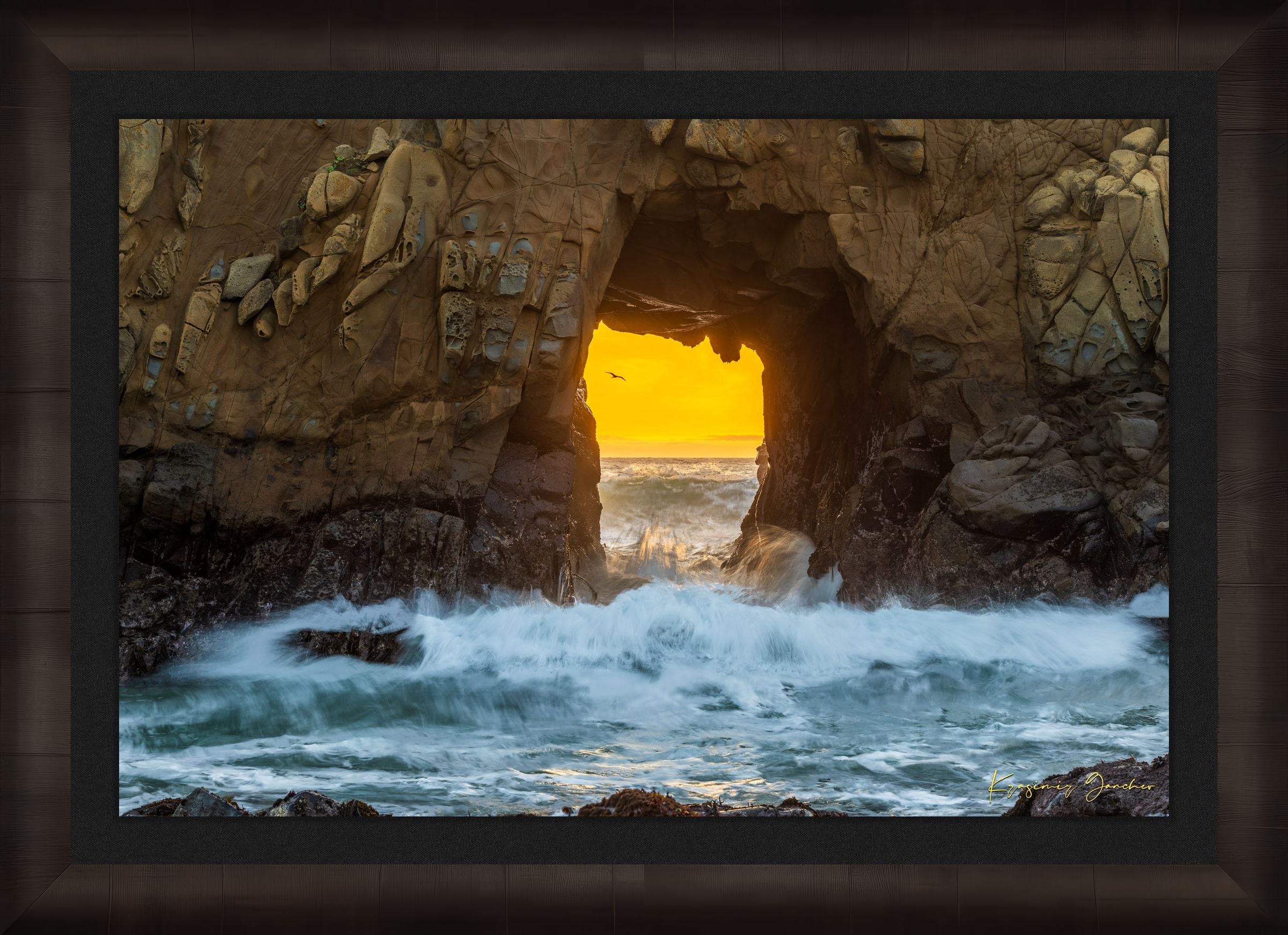 Natural rock arch on the Pacific coast of Big Sur framed by a vivid sunset, wave motion softened by long exposure. #Finish_Roma Dark Ash Frame & Dark Liner