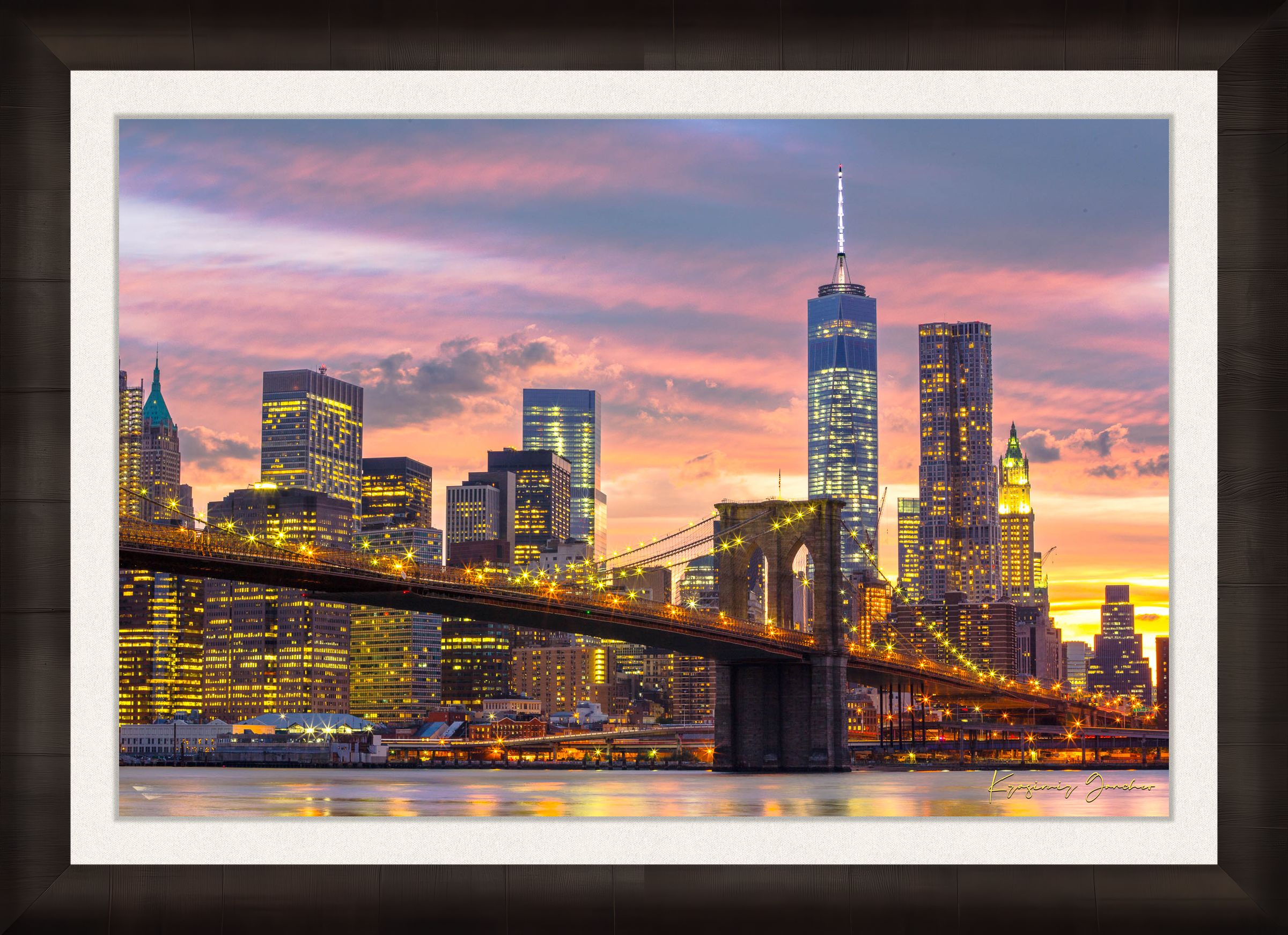 The Brooklyn Bridge viewed from Manhattan during evening hours as sunlight fades into artificial lighting under cloudy skies. #Finish_Roma Dark Ash Frame & Bright Liner