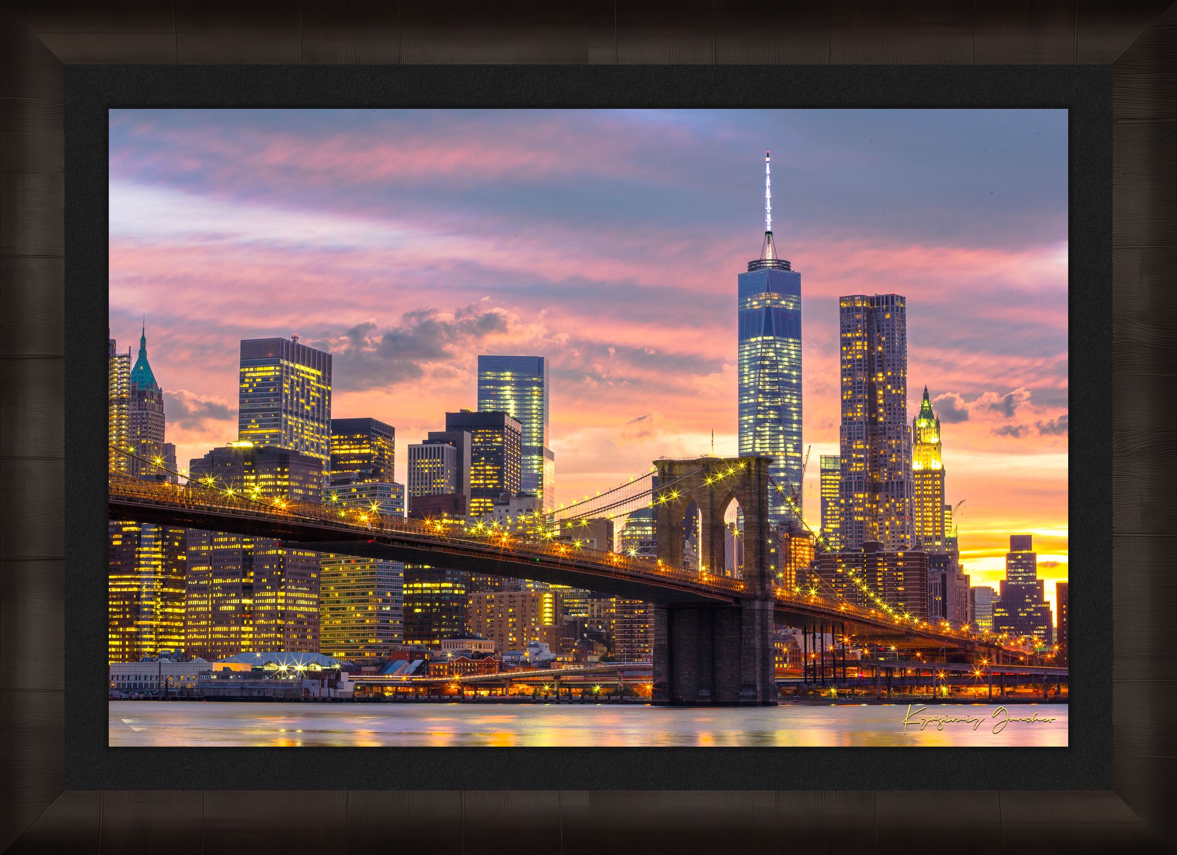 The Brooklyn Bridge viewed from Manhattan during evening hours as sunlight fades into artificial lighting under cloudy skies. #Finish_Roma Dark Ash Frame & Dark Liner