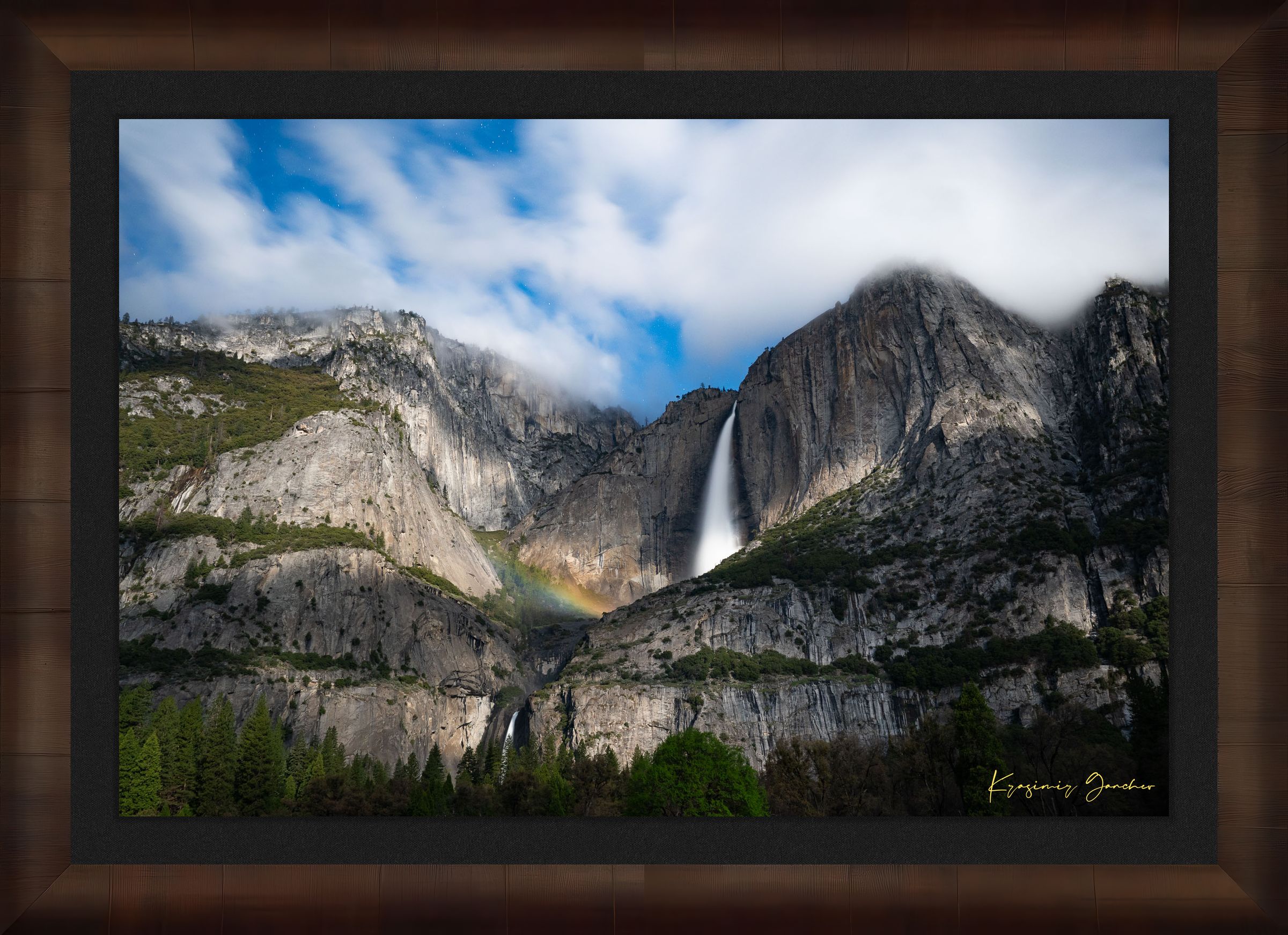 Yosemite Falls at night under starlight, illuminated by a faint silvery moonbow arching above the cascade within a cloudy mountain valley. #Finish_Roma Cigar Leaf Frame & Dark Liner