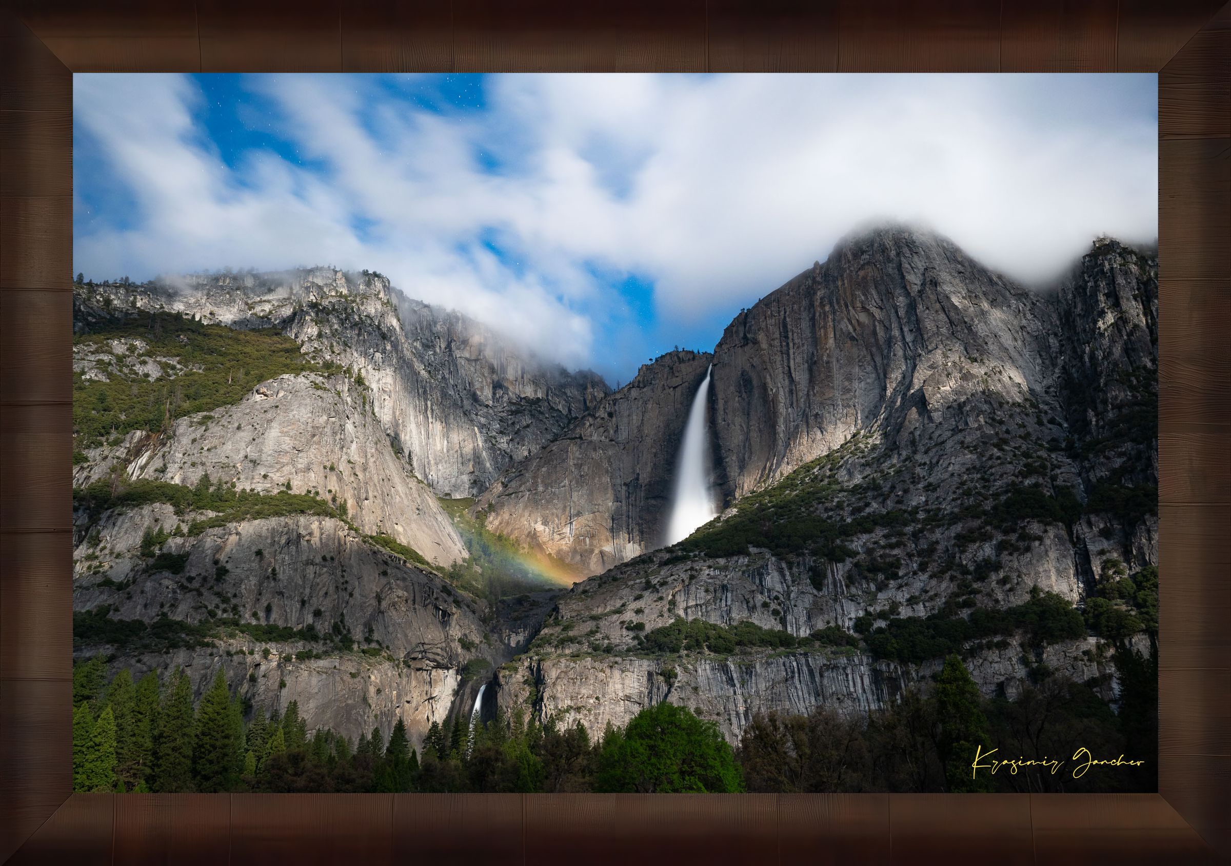 Yosemite Falls at night under starlight, illuminated by a faint silvery moonbow arching above the cascade within a cloudy mountain valley. #Finish_Roma Cigar Leaf Frame