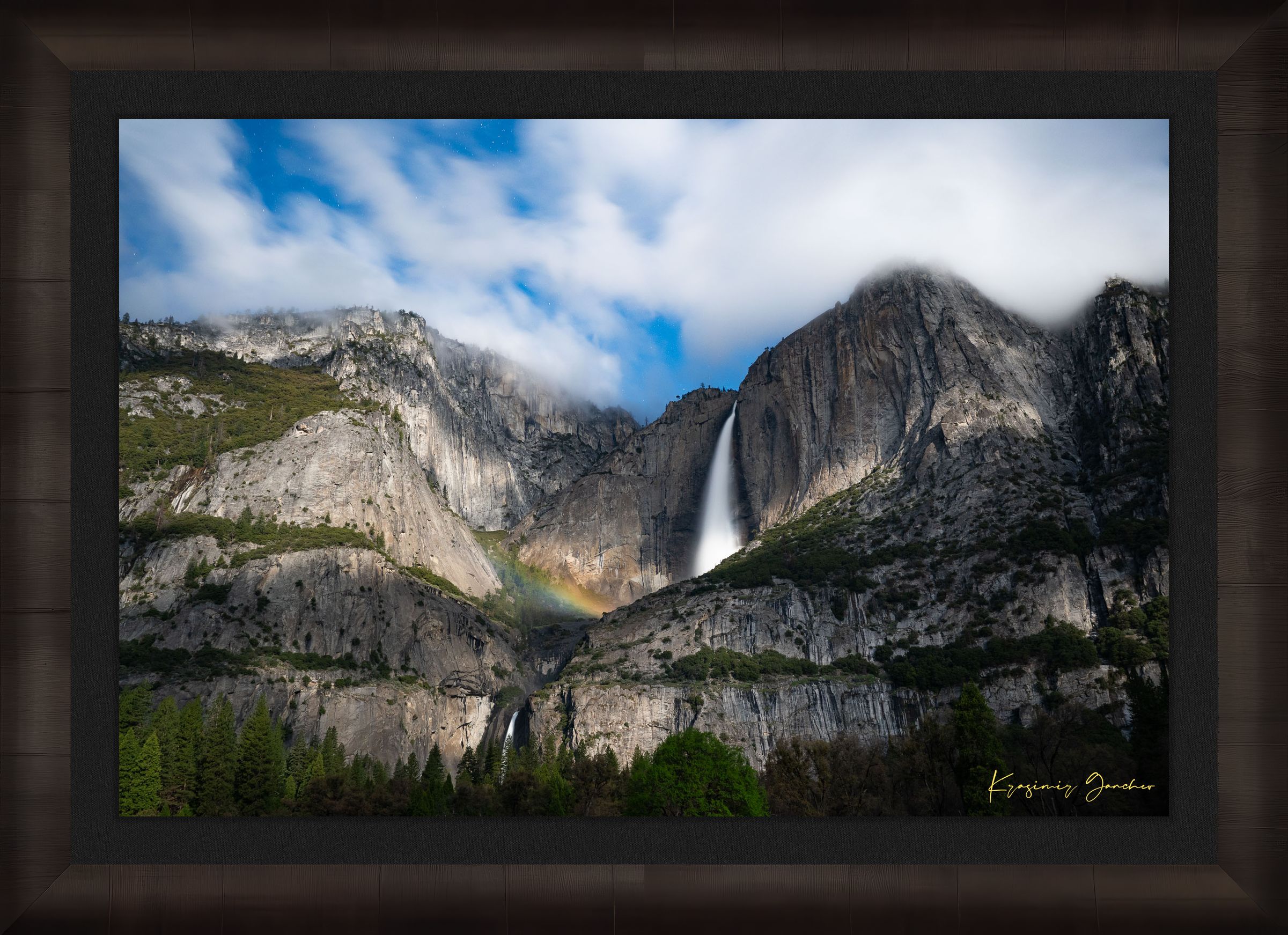 Yosemite Falls at night under starlight, illuminated by a faint silvery moonbow arching above the cascade within a cloudy mountain valley. #Finish_Roma Dark Ash Frame & Dark Liner