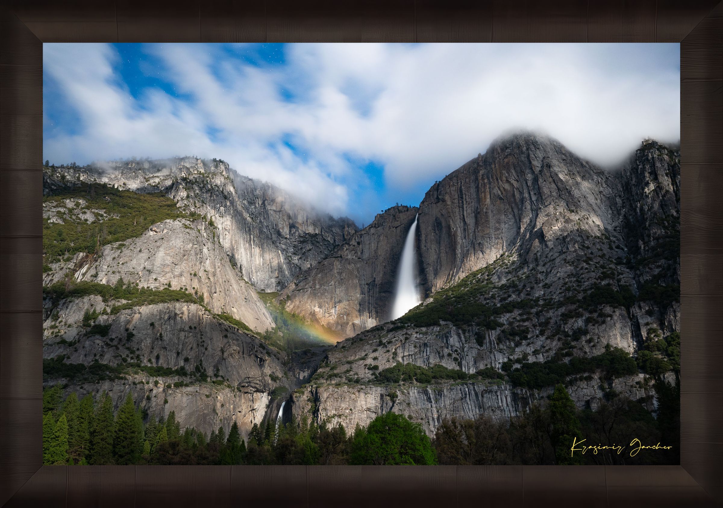 Yosemite Falls at night under starlight, illuminated by a faint silvery moonbow arching above the cascade within a cloudy mountain valley. #Finish_Roma Dark Ash Frame
