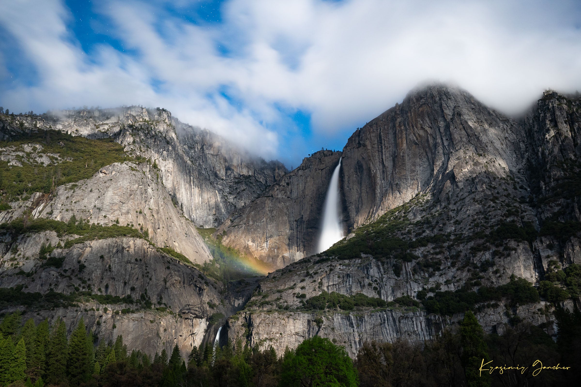 Yosemite Falls at night under starlight, illuminated by a faint silvery moonbow arching above the cascade within a cloudy mountain valley. #Finish_Acrylic Recess