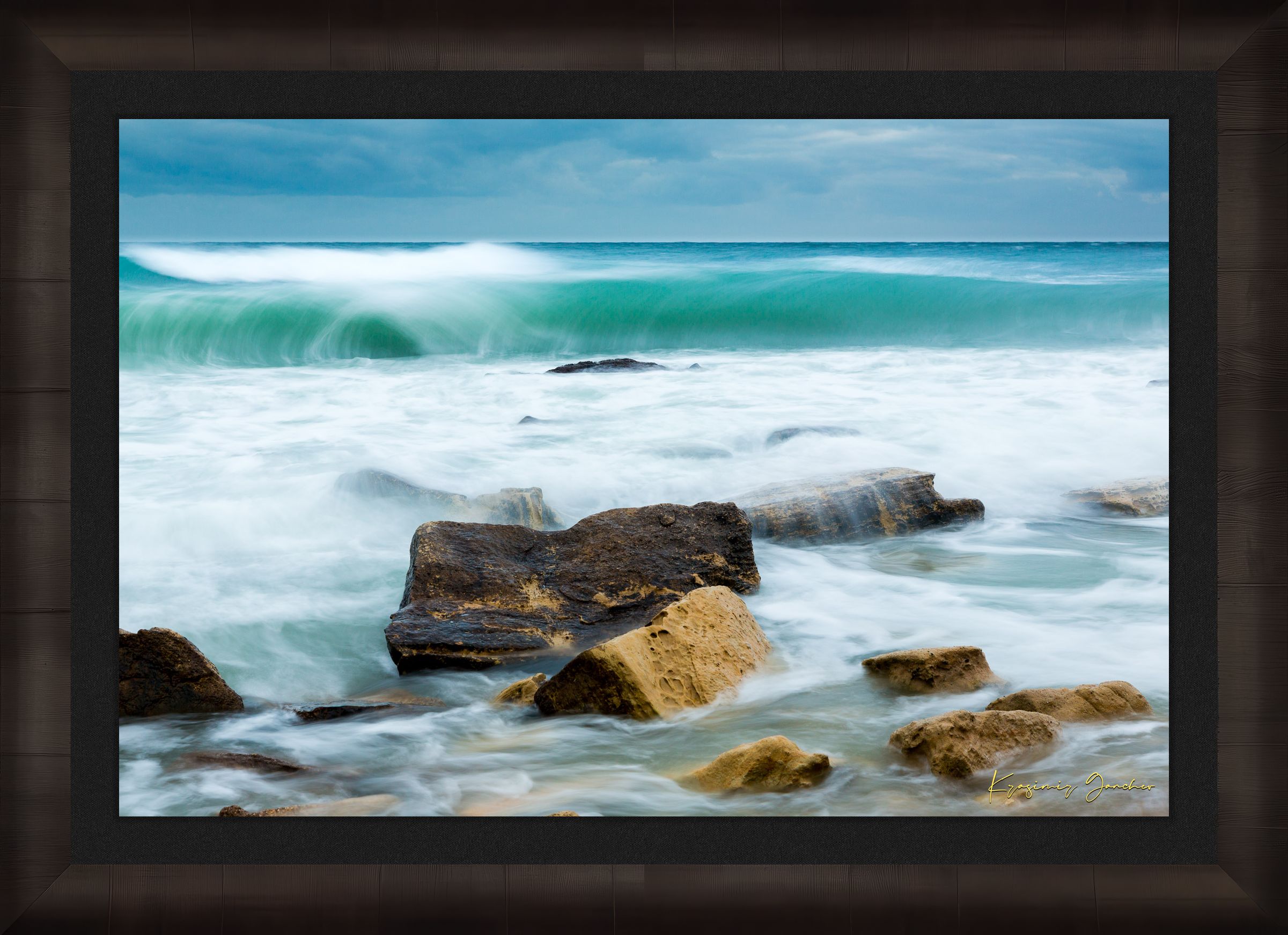 Waves from the sea crash against coastal boulder formations near Fichoza, Bulgaria during daylight with cloudy weather. #Finish_Roma Dark Ash Frame & Dark Liner