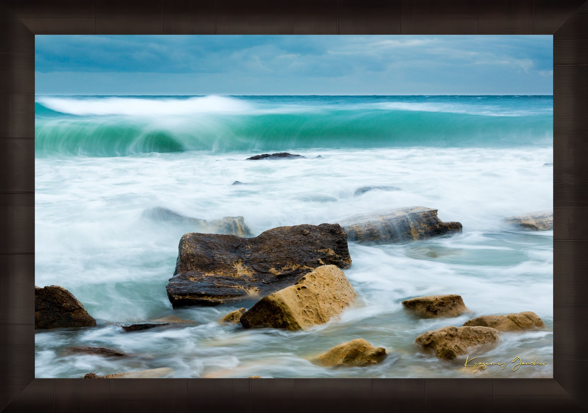 Waves from the sea crash against coastal boulder formations near Fichoza, Bulgaria during daylight with cloudy weather. #Finish_Roma Dark Ash Frame