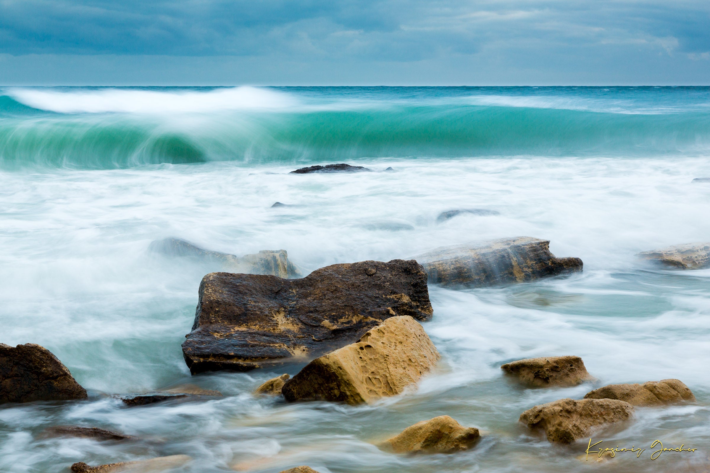 Waves from the sea crash against coastal boulder formations near Fichoza, Bulgaria during daylight with cloudy weather. #Finish_Acrylic Recess