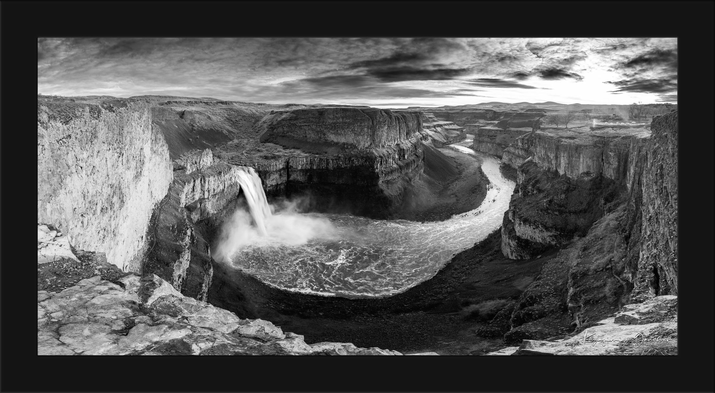 Wide-angle monochrome view of Palouse Falls in Washington State cascading into a rugged canyon with clouds above. #Finish_Roma Satin Black Frame