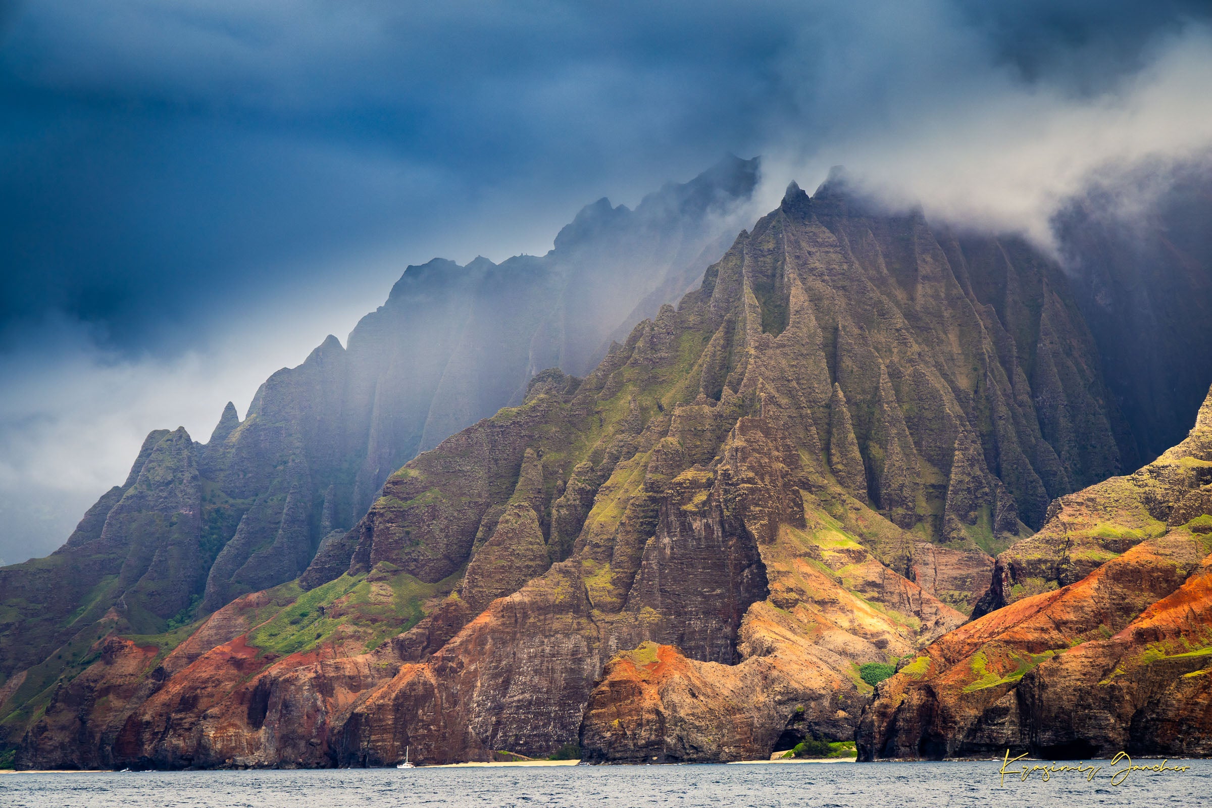 Rugged coastal cliff face rising from the Pacific Ocean at Napali Coast, Kauai, with light breaking through storm clouds. #Finish_Acrylic Recess