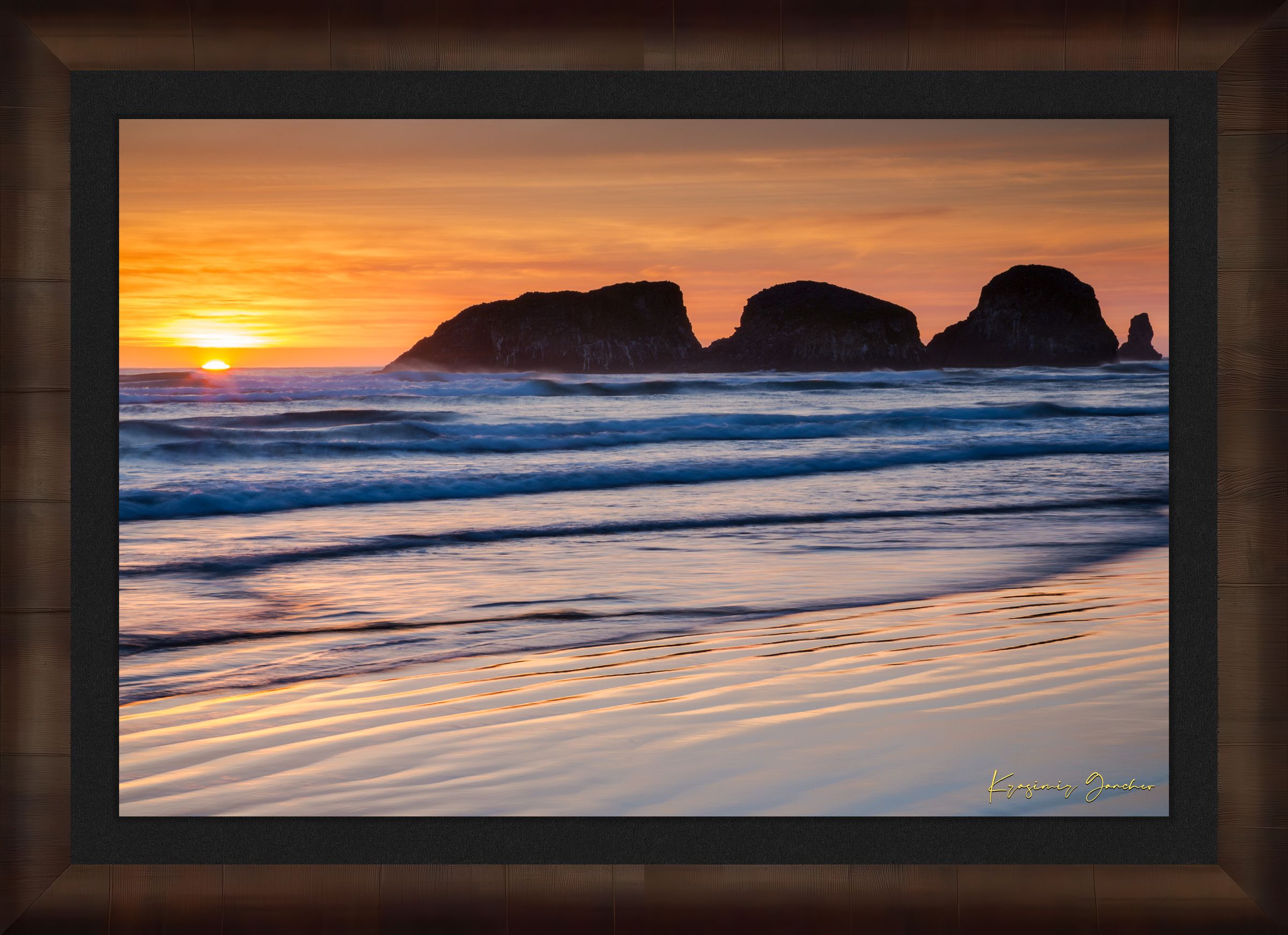 Bird Rock at Cannon Beach, Oregon, during sunset with reflections in the wet sand and ocean under cloudy skies. #Finish_Roma Cigar Leaf Frame & Dark Liner