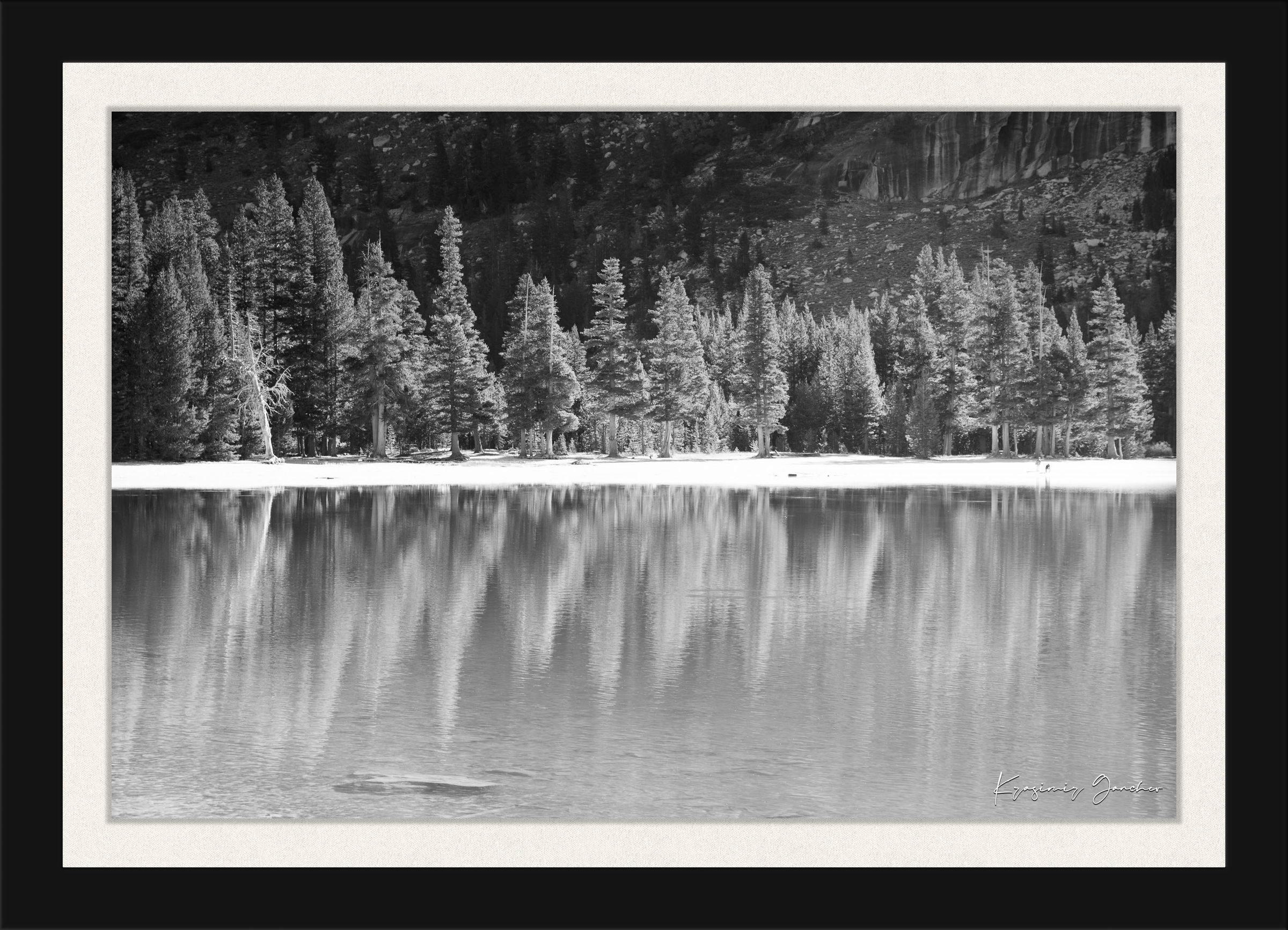 Still mirror-like lake surrounded by pines under clear daylight in Yosemite National Park, showing perfect symmetry. #Finish_Roma Satin Black Frame & Bright Liner