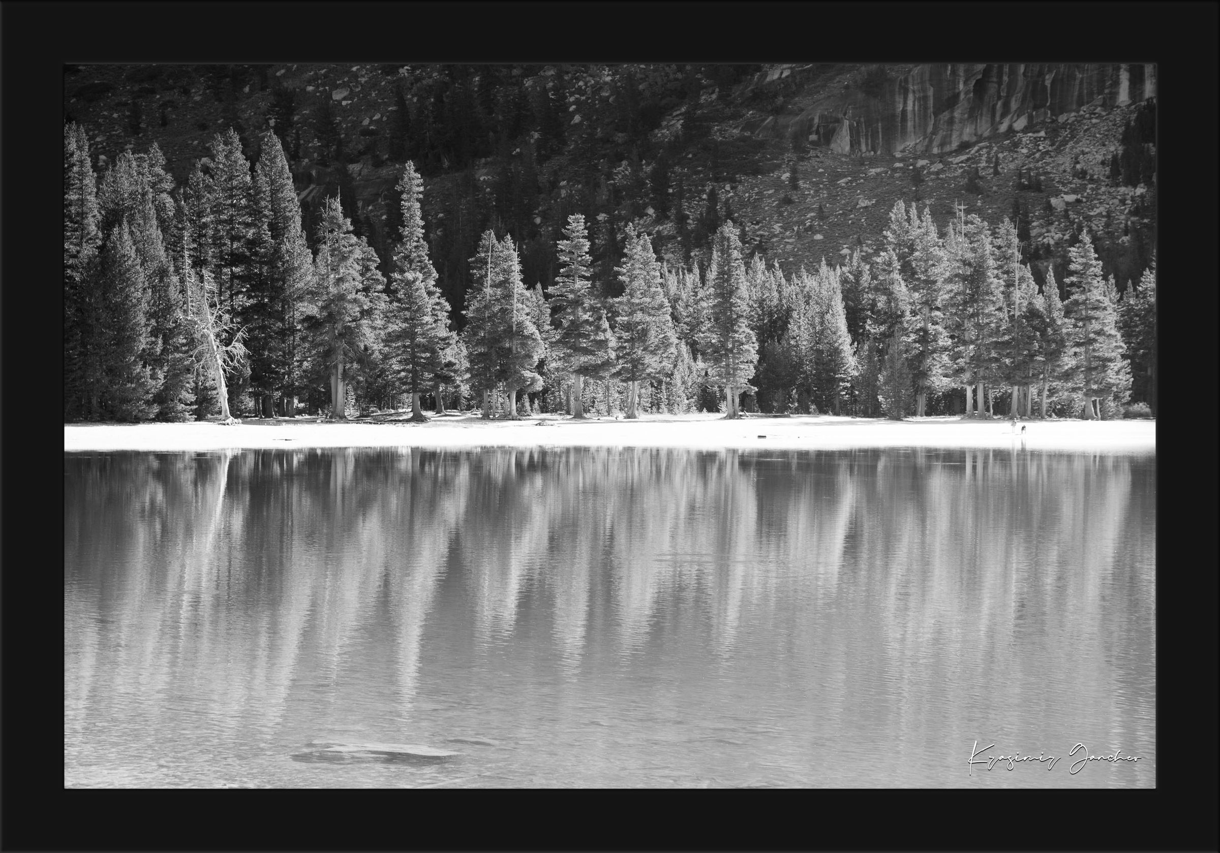 Still mirror-like lake surrounded by pines under clear daylight in Yosemite National Park, showing perfect symmetry. #Finish_Roma Satin Black Frame