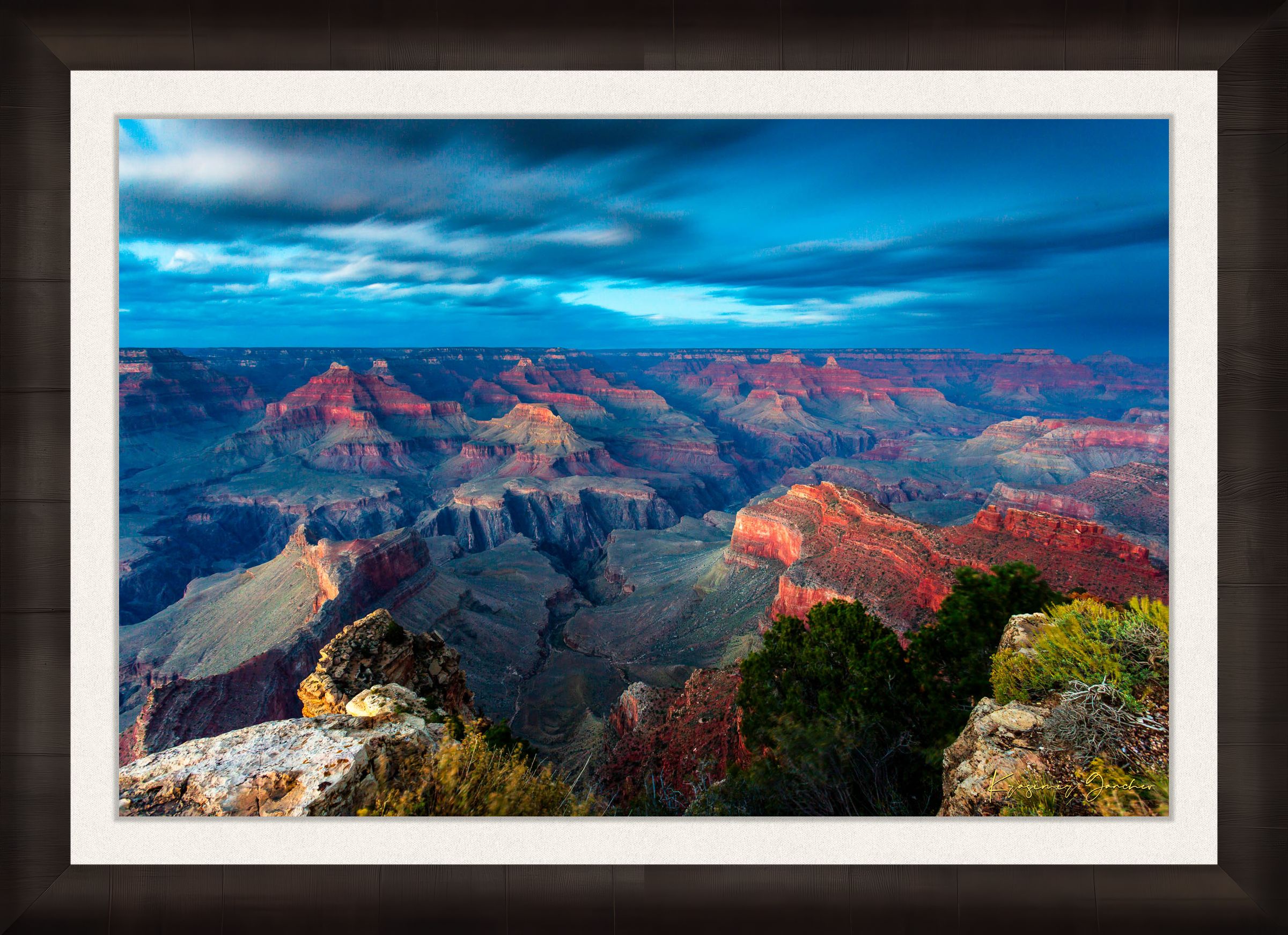 Grand Canyon under a dramatic sky at sunset, storm clouds gathering over the canyon rim during hazy weather. #Finish_Roma Dark Ash Frame & Bright Liner