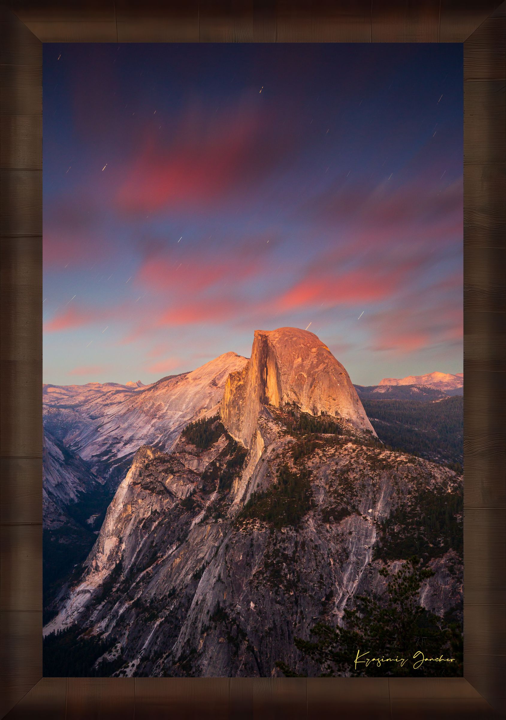Granite monolith of Half Dome illuminated by dusk and stars, set against a sky filled with star trails above Yosemite National Park. #Finish_Roma Cigar Leaf Frame
