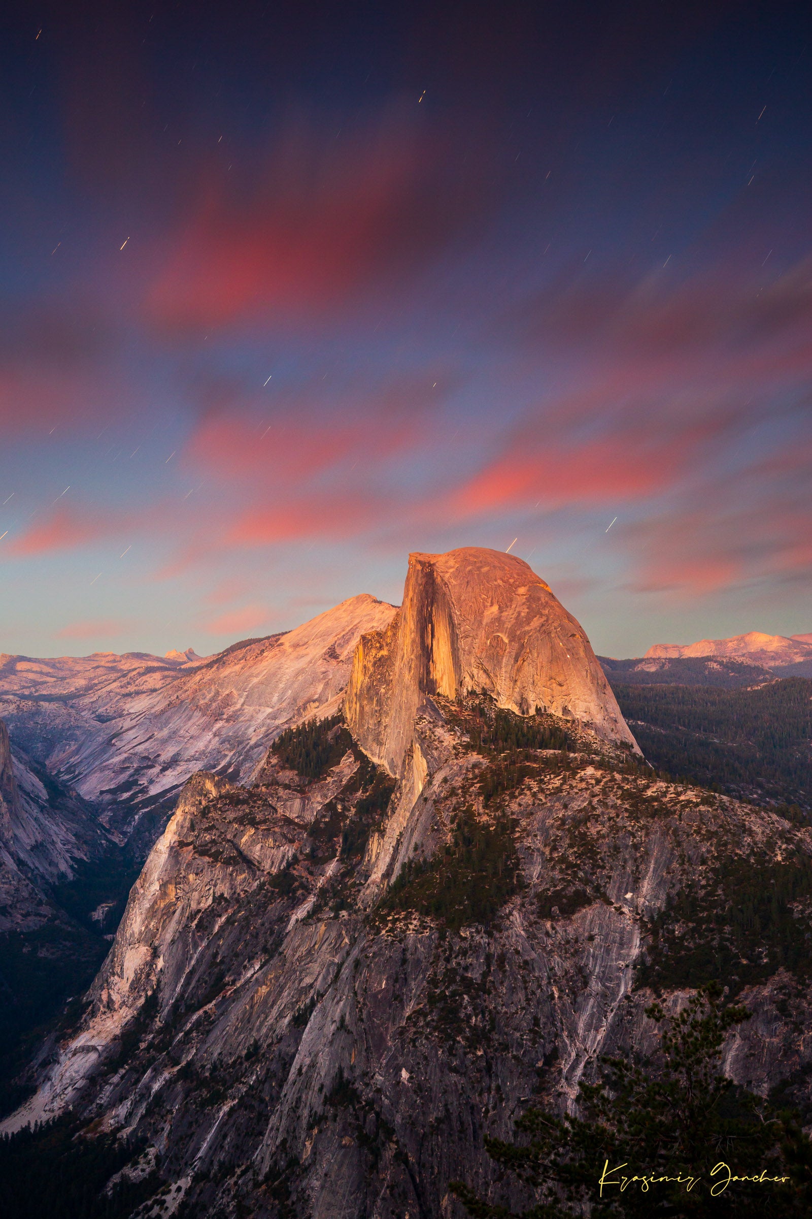 Granite monolith of Half Dome illuminated by dusk and stars, set against a sky filled with star trails above Yosemite National Park. #Finish_Acrylic Recess