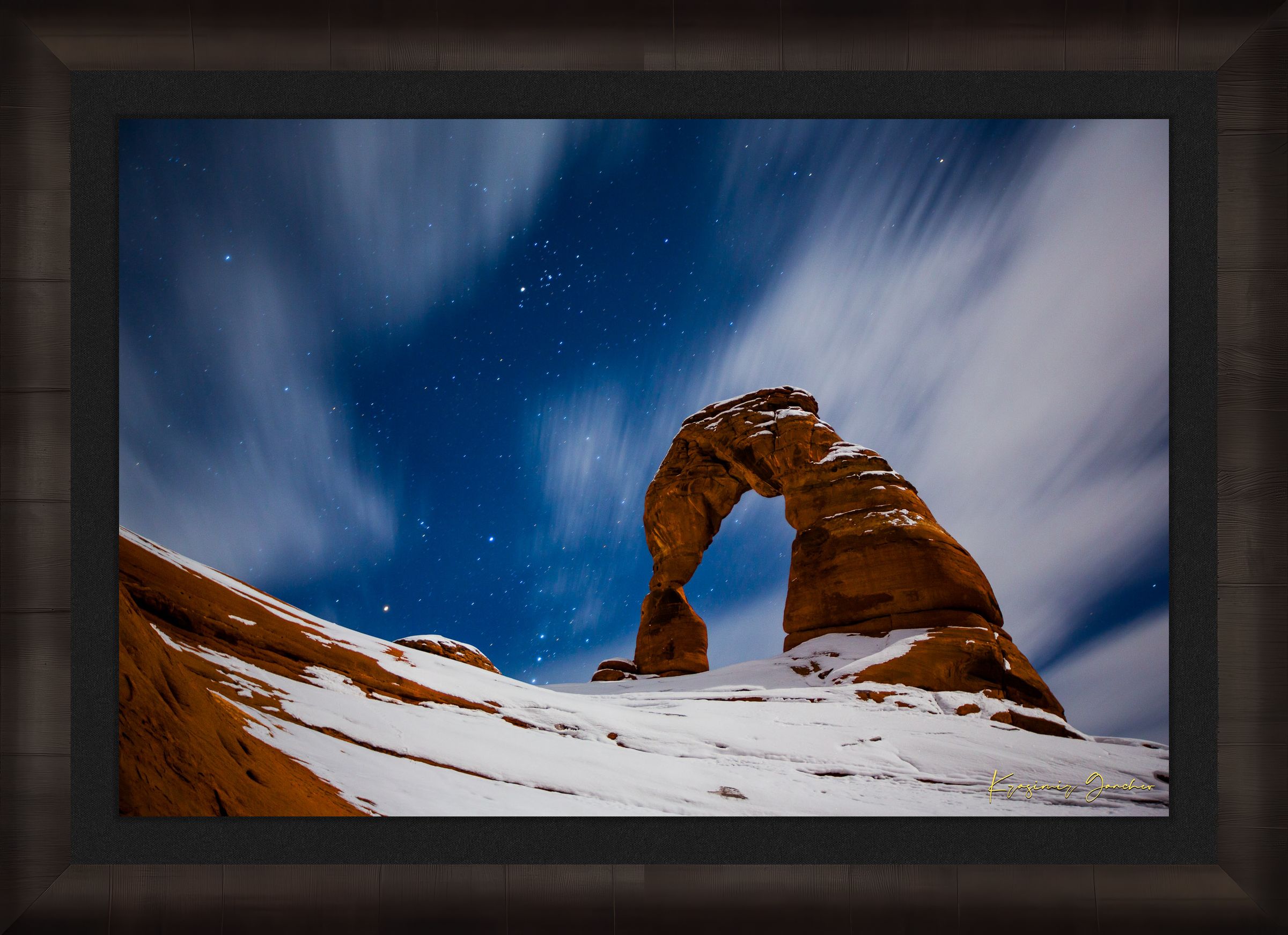 Iconic arch formation in Arches National Park captured during nighttime with starlight and light snow enhancing the serene desert scene. #Finish_Roma Dark Ash Frame & Dark Liner