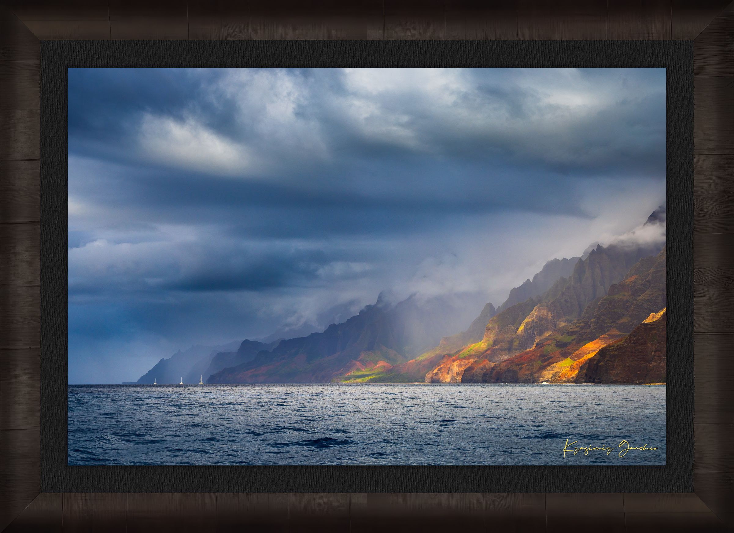 Cliffs and coastal terrain of Napali Coast, Kauai, under daylight with rain showers and cloud cover. #Finish_Roma Dark Ash Frame & Dark Liner
